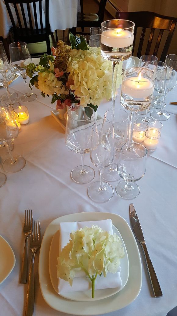a table with wine glasses and candles