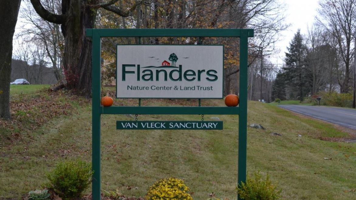 a sign in a grassy area