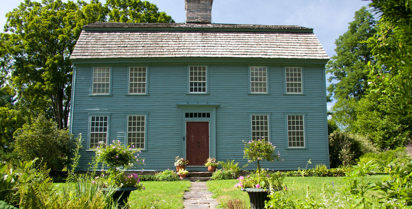 a house with a garden and a stone walkway