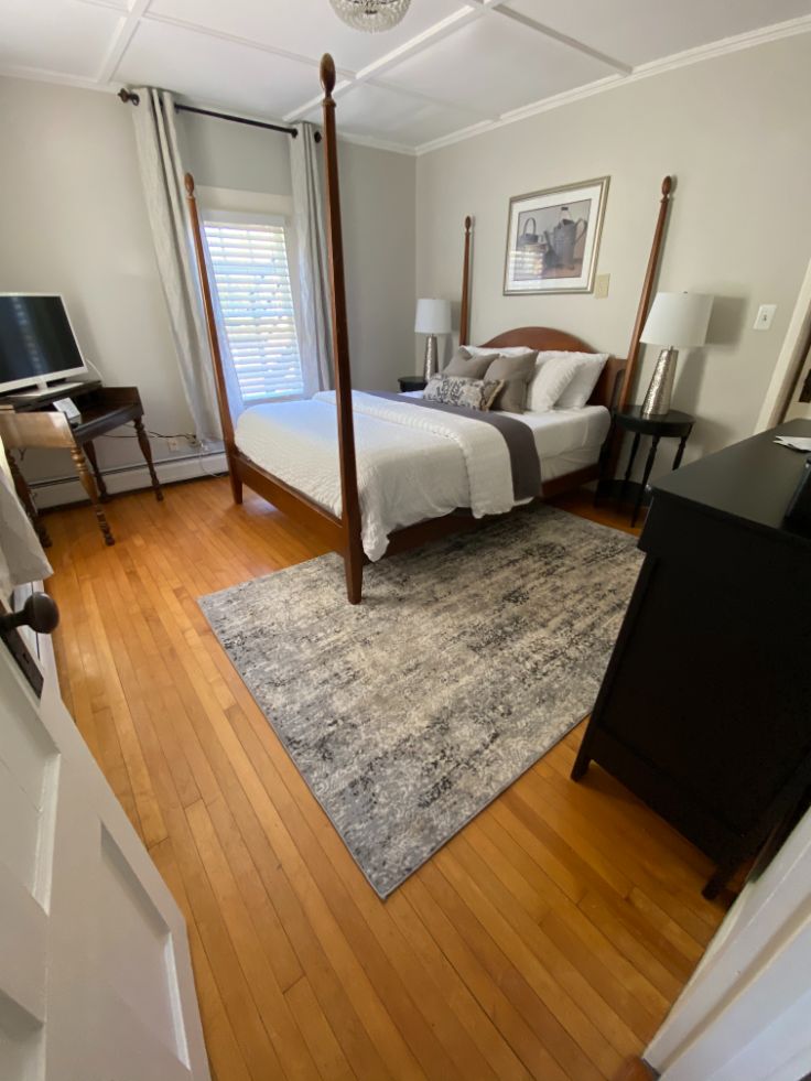 a bedroom with a four poster bed