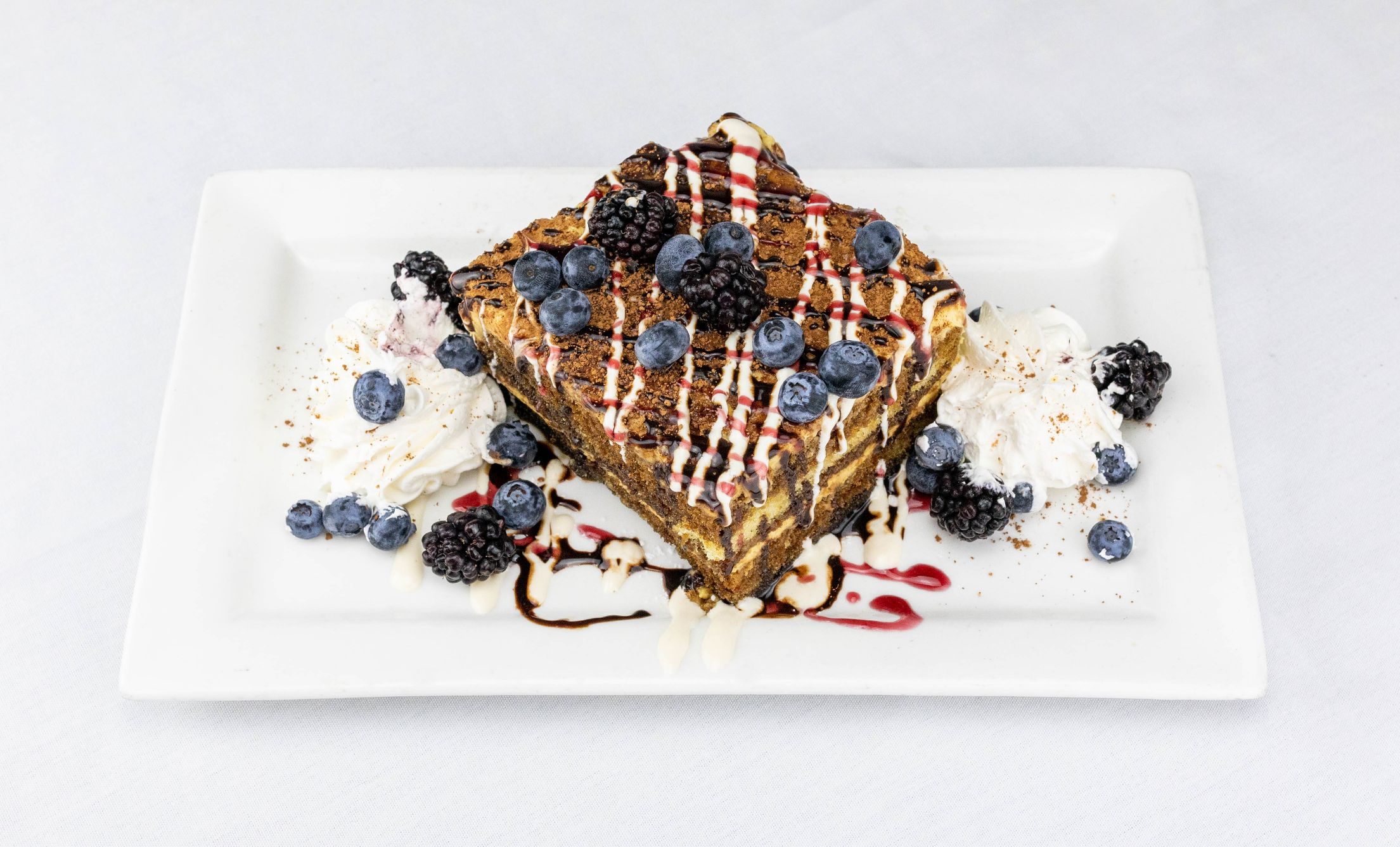 a plate of food with berries and whipped cream