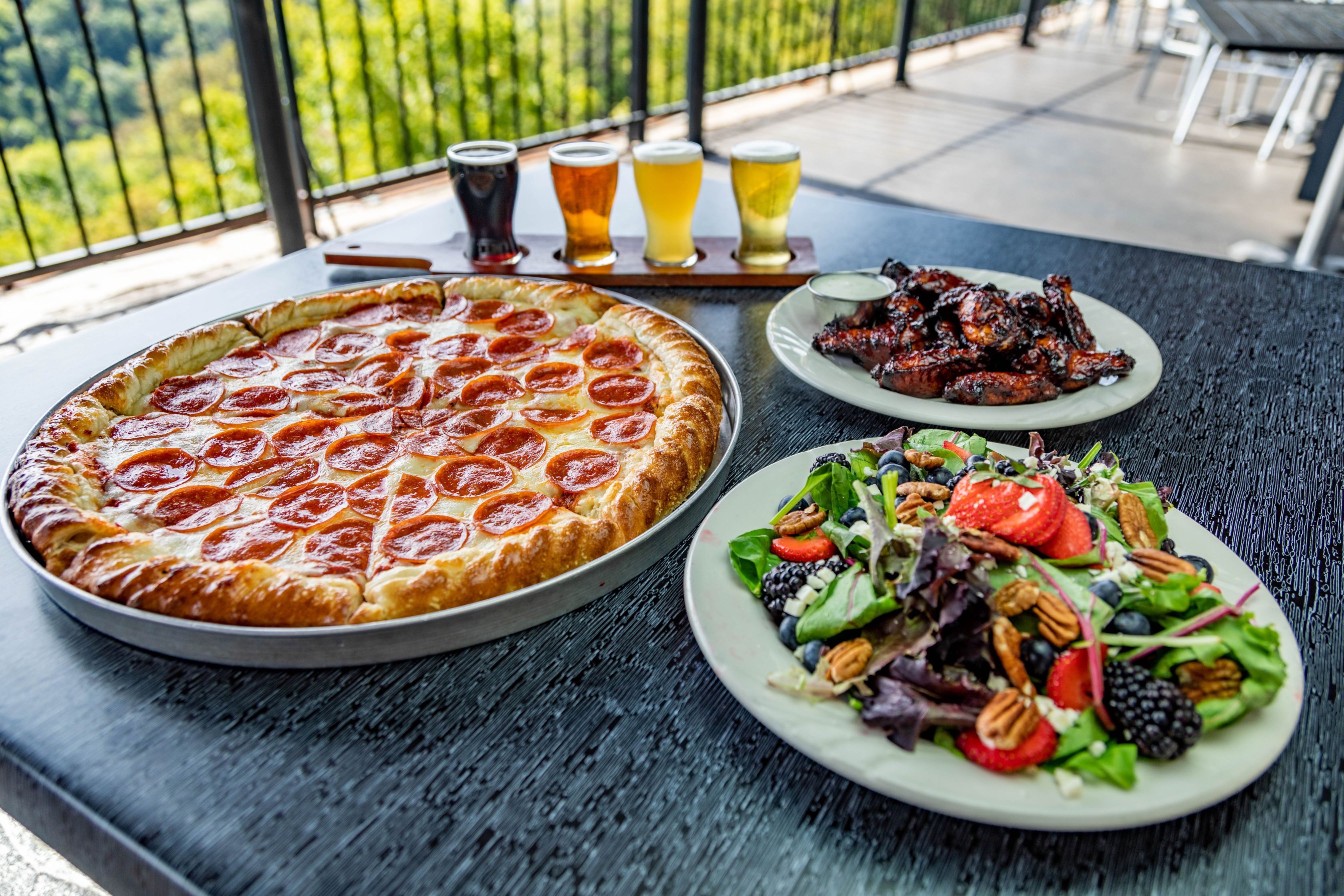 a pizza and salad on a table