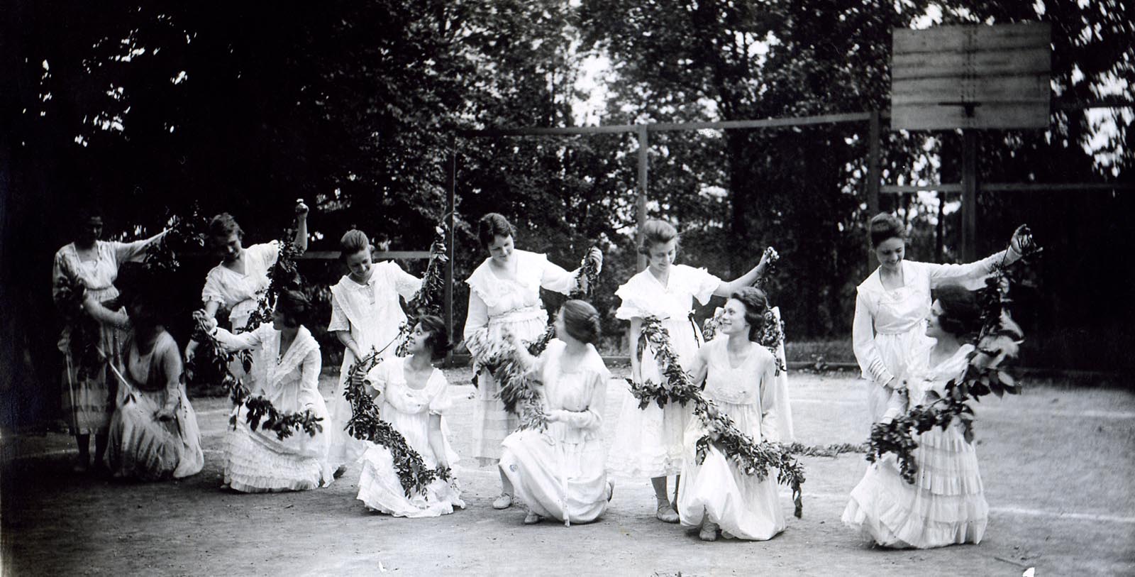 a group of women holding leaves