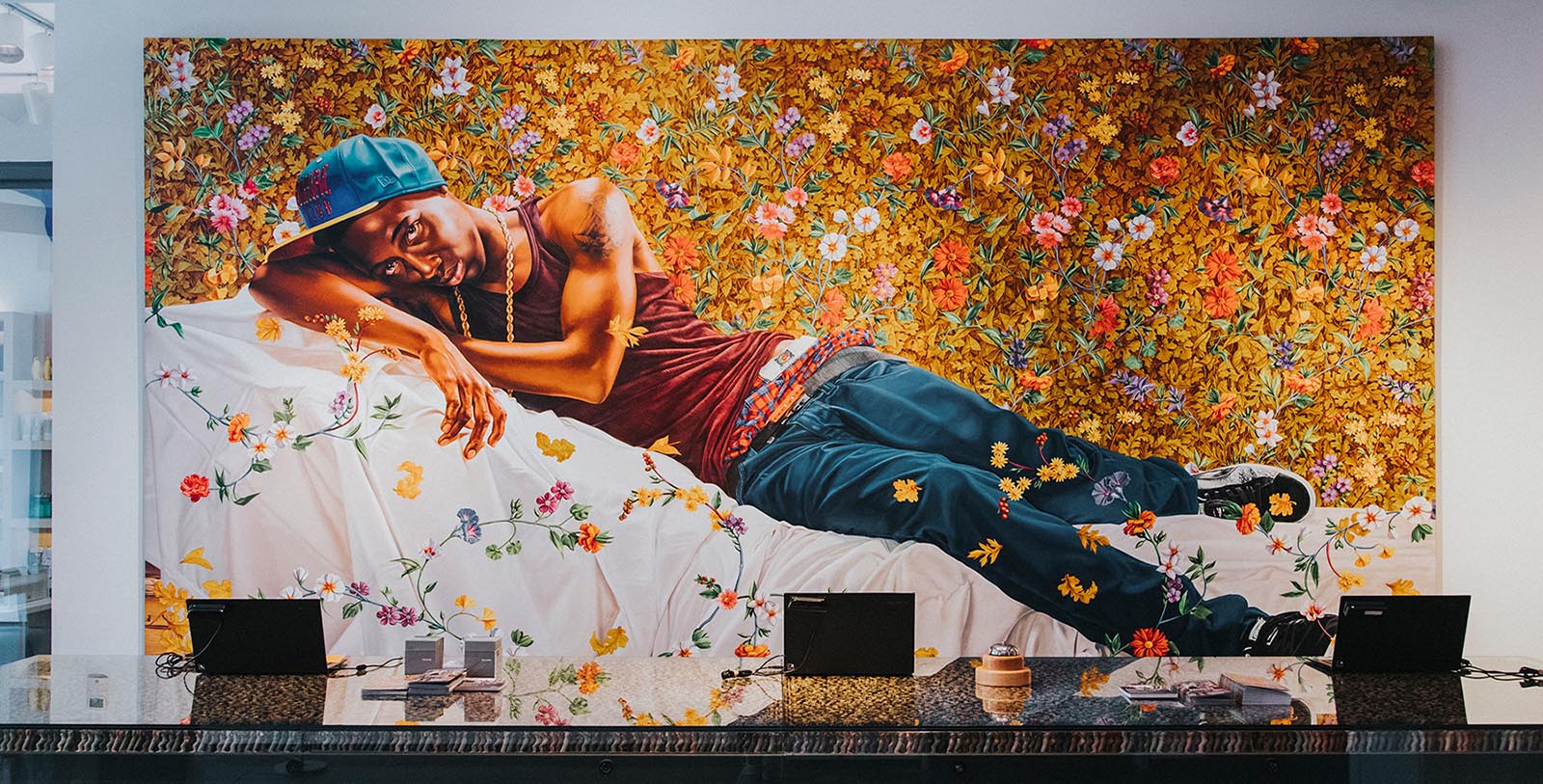 a man lying on a bed with flowers on it