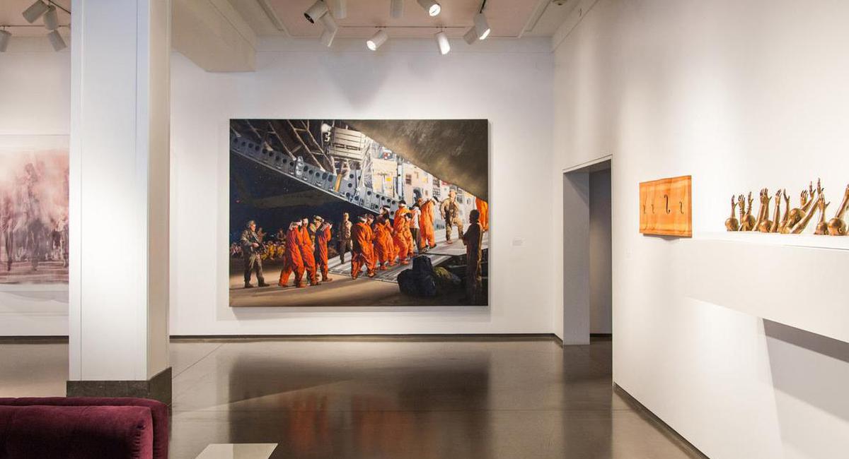 a painting of people in orange robes on a white wall