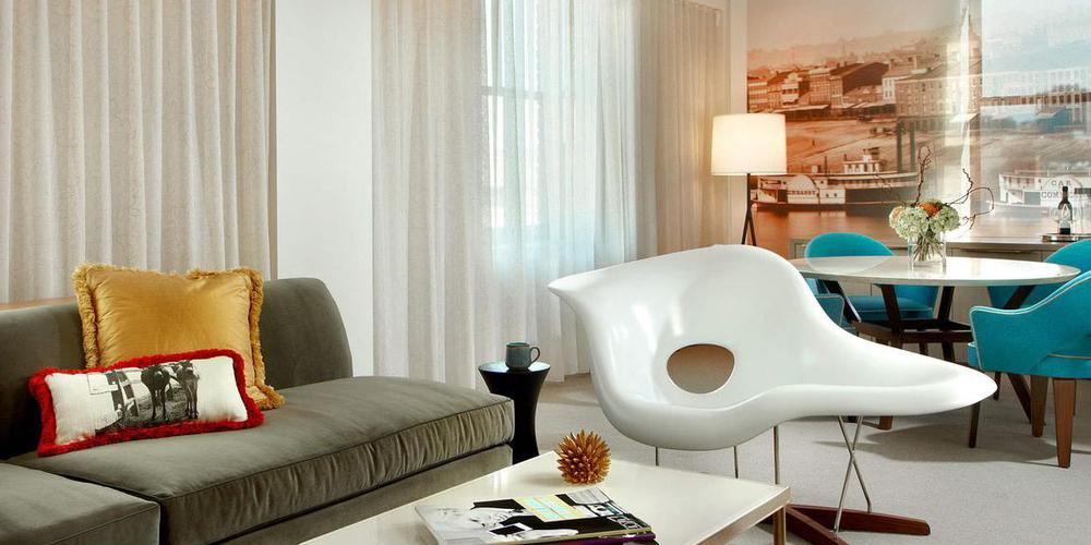 a living room with a white chair and a table