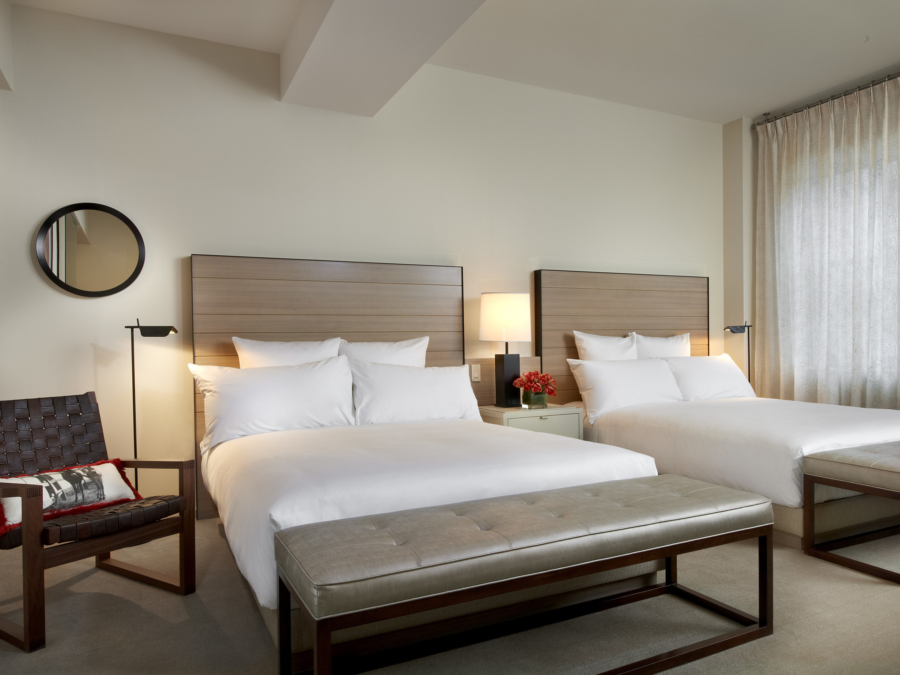 a room with two beds and a bench