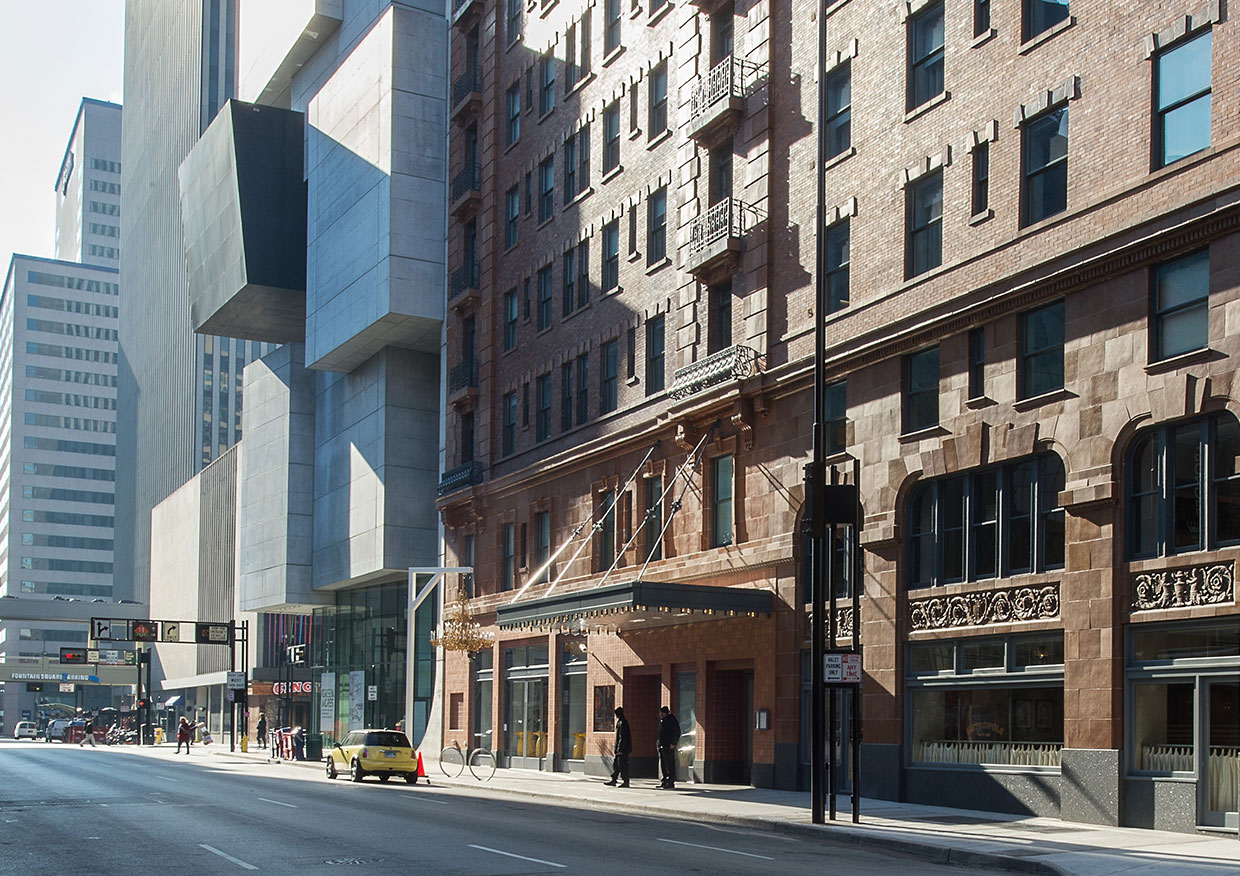 a street with a building and people walking on it