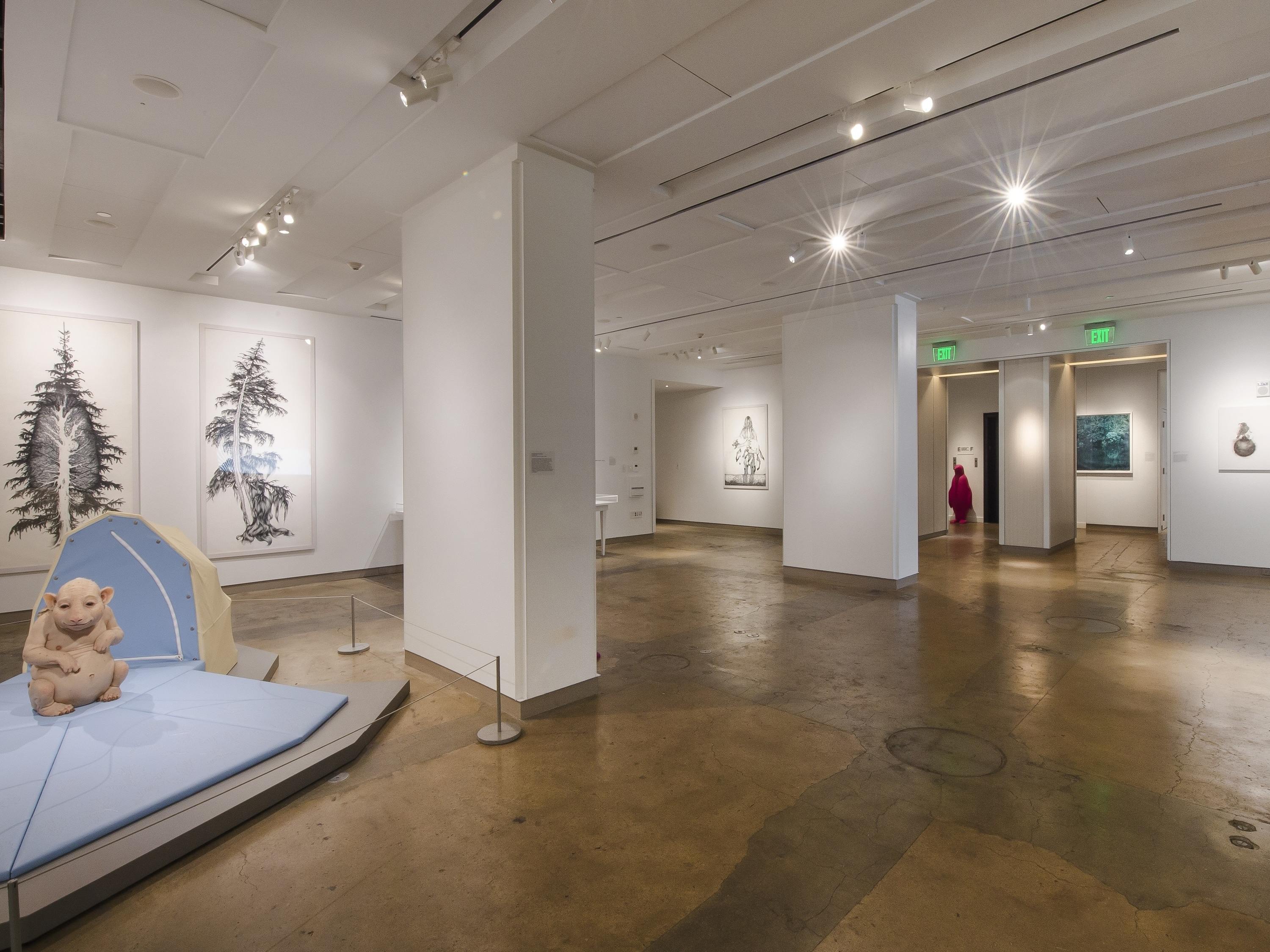 a room with a bed and paintings on the wall