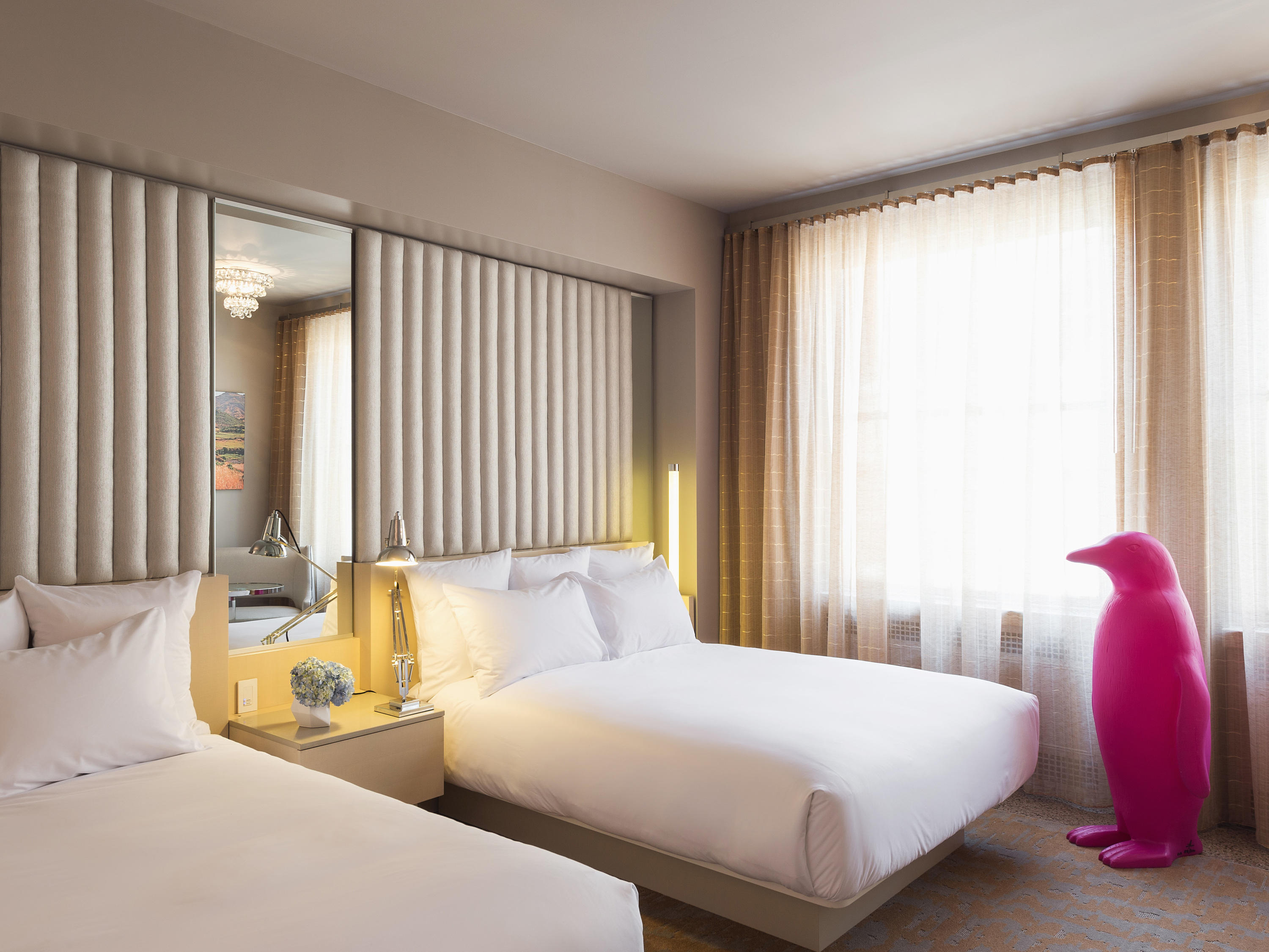 a person in a pink garment standing in a hotel room
