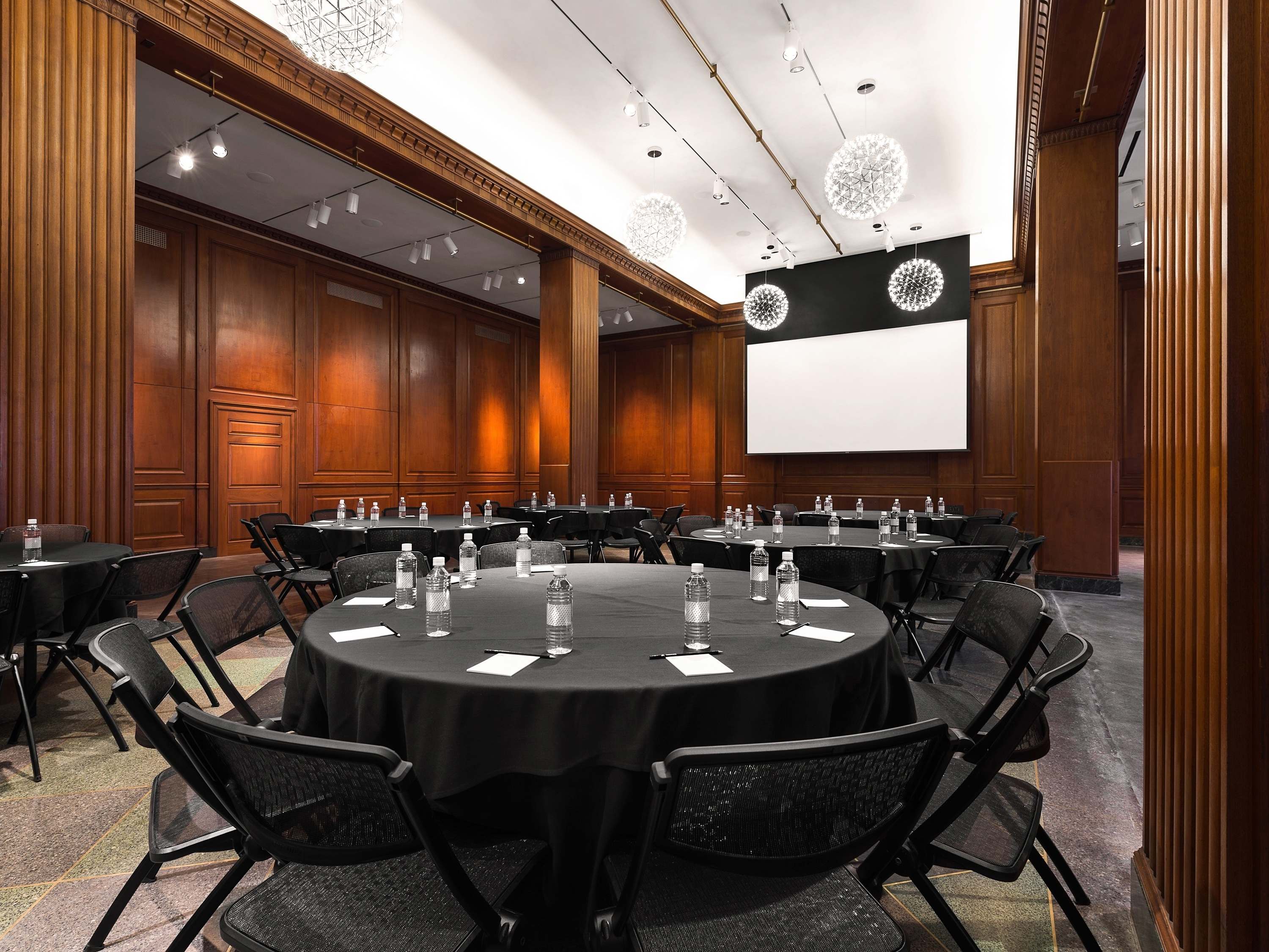 a room with round tables and chairs