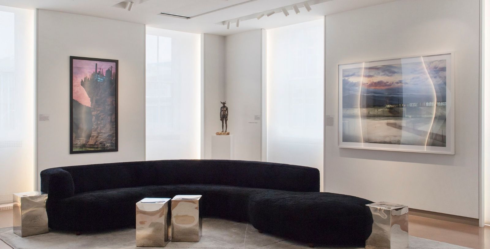 a black couch in a room with art on the wall
