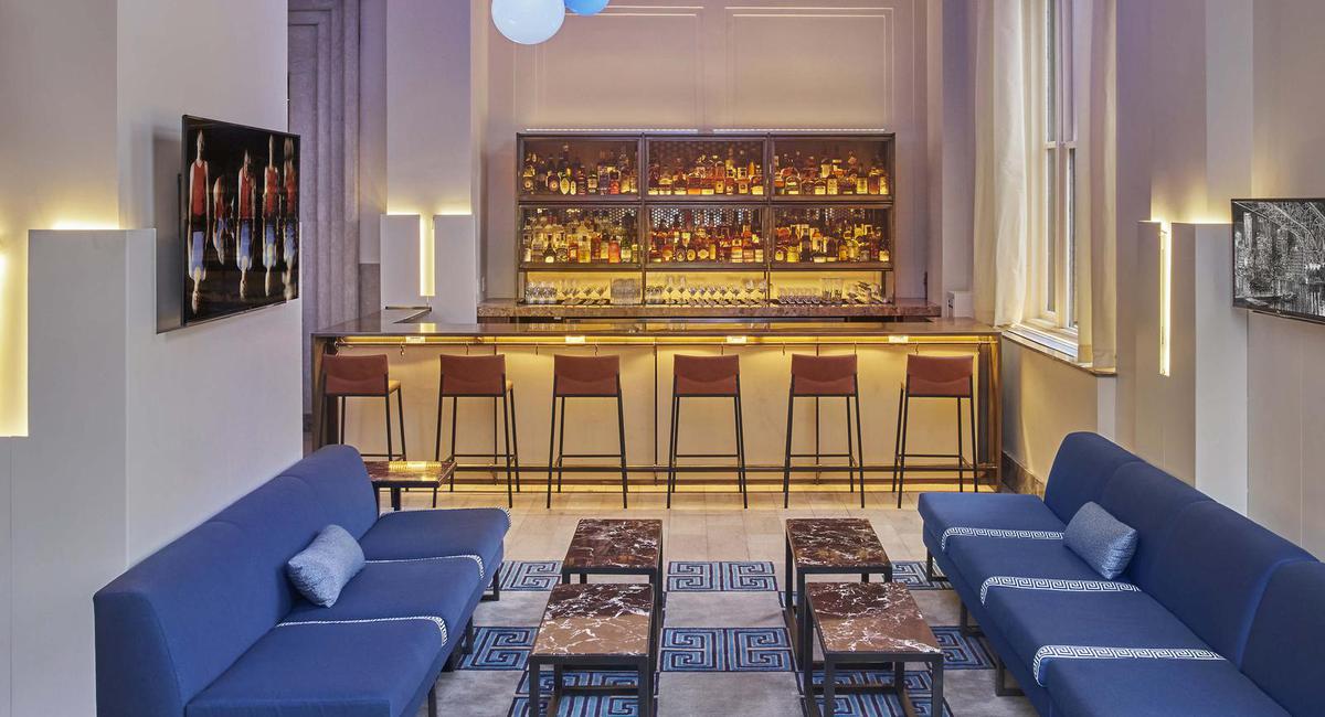 a room with a bar and a blue couch