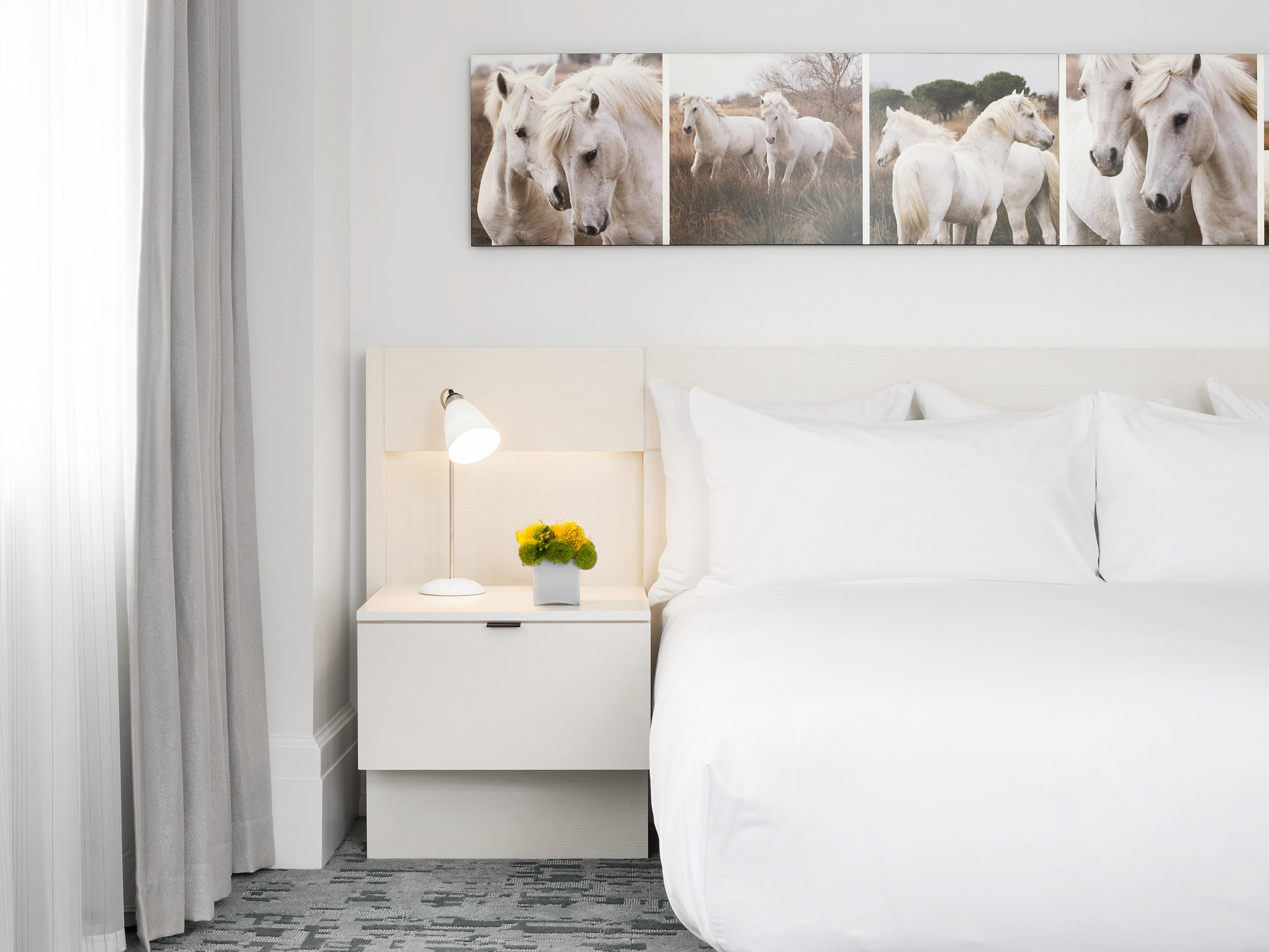 a bed with a picture of horses