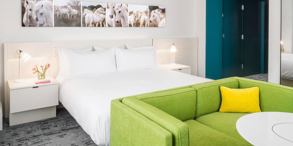 a bed and a green couch in a room