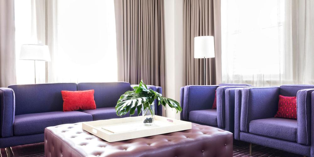 a room with purple couches and a white tray with a plant on it