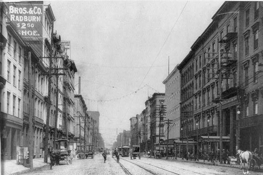 a street with buildings and people walking