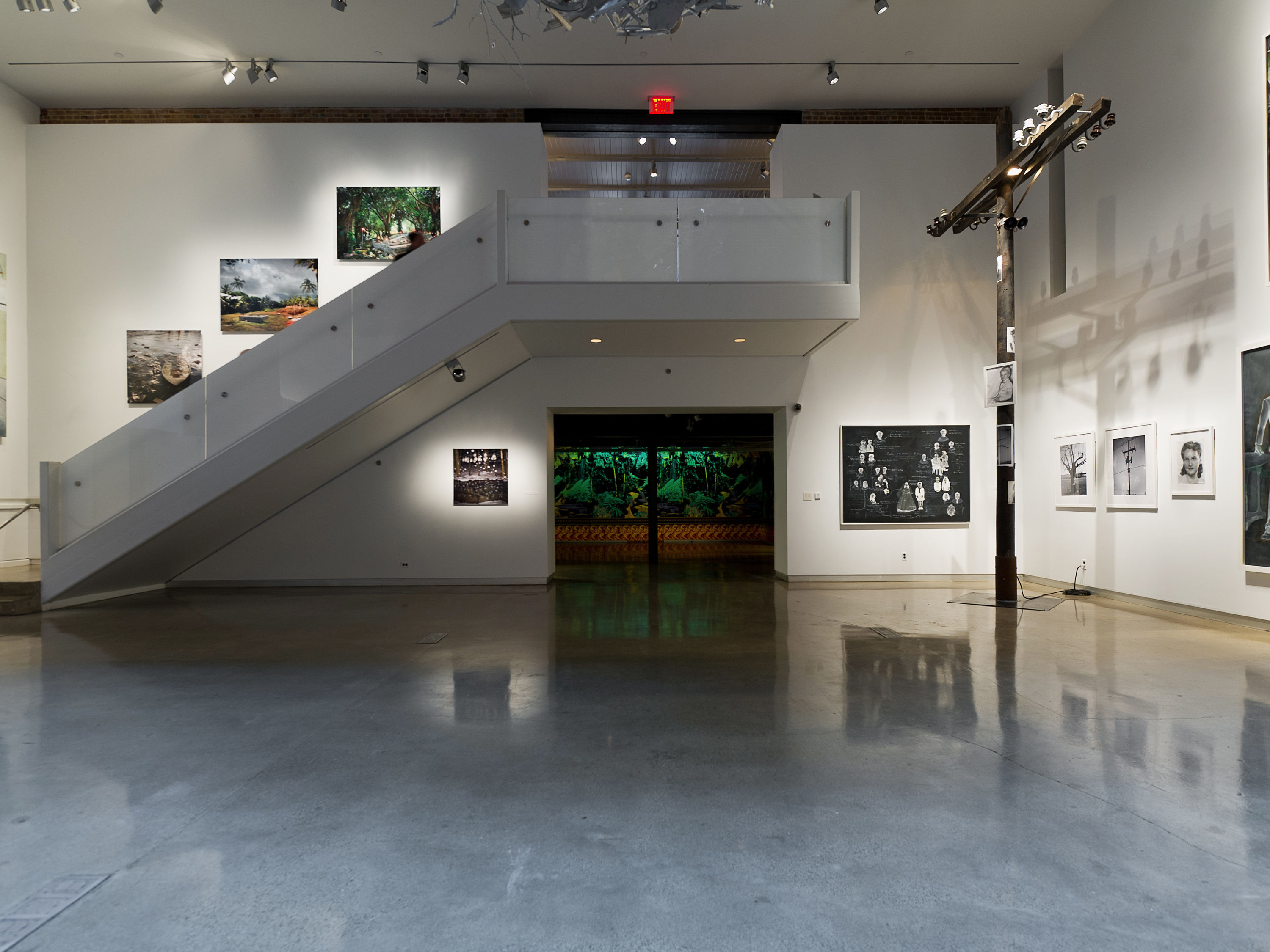 a room with a staircase and art on the wall