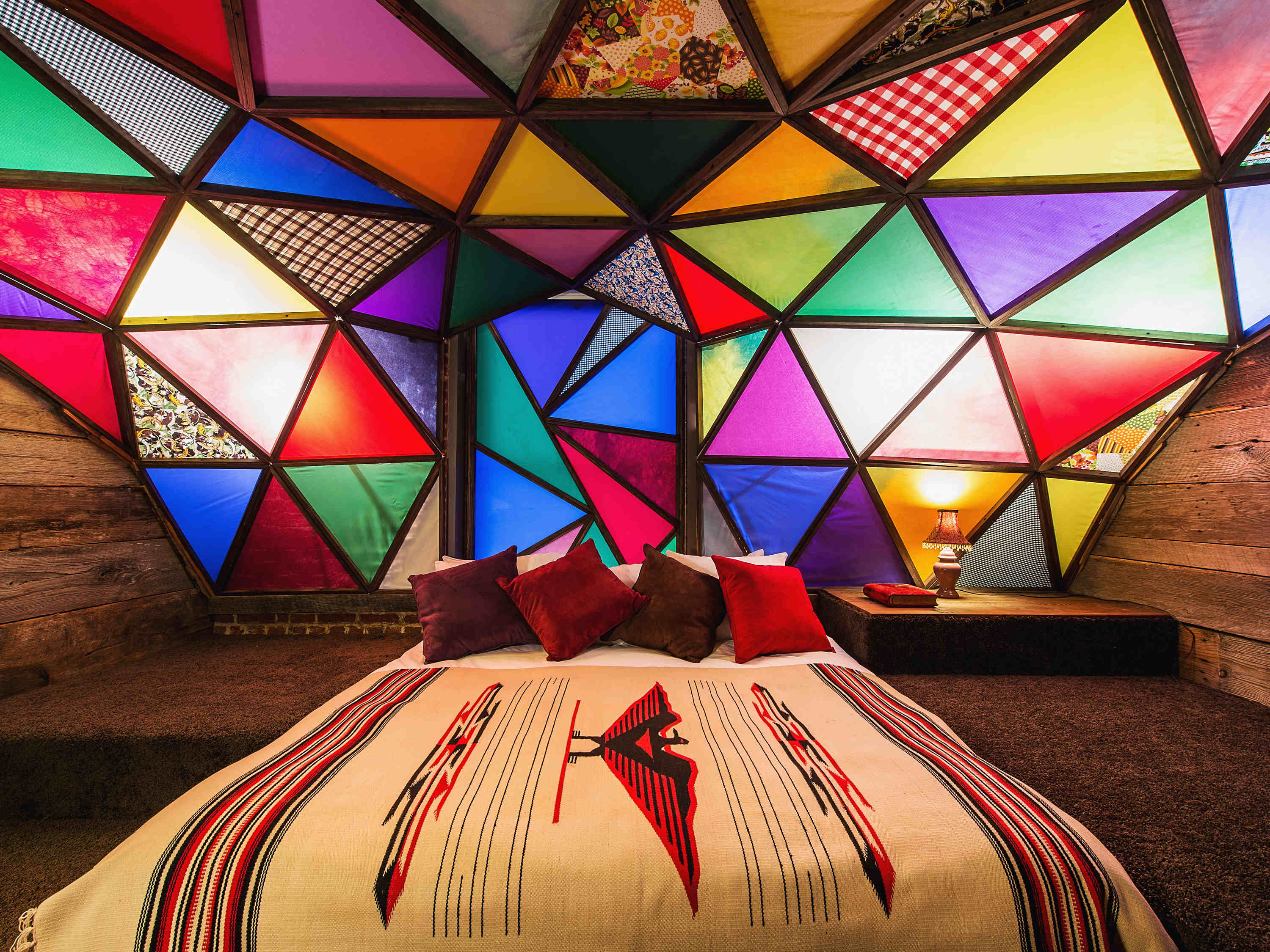 a bed with colorful triangles in the ceiling