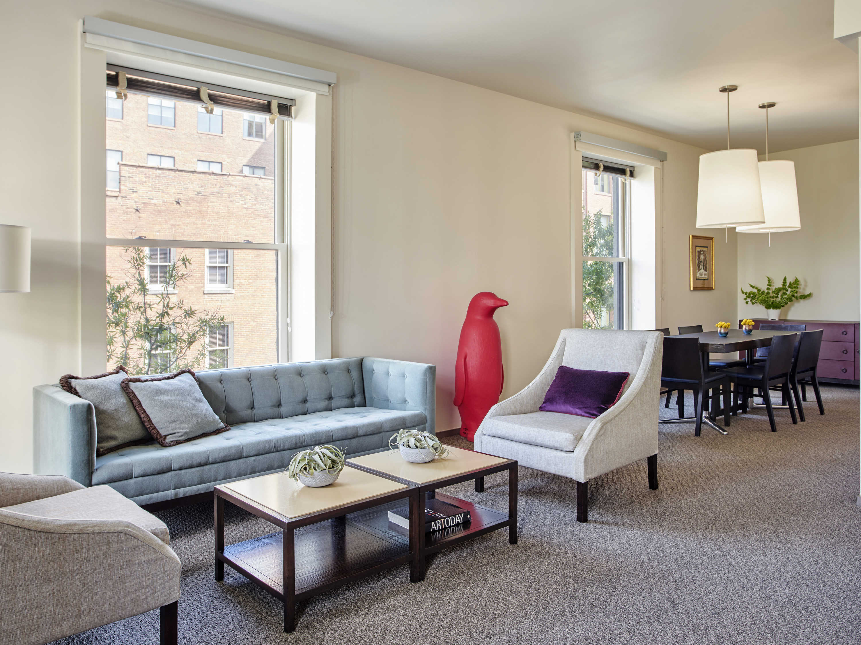 a living room with couches and tables