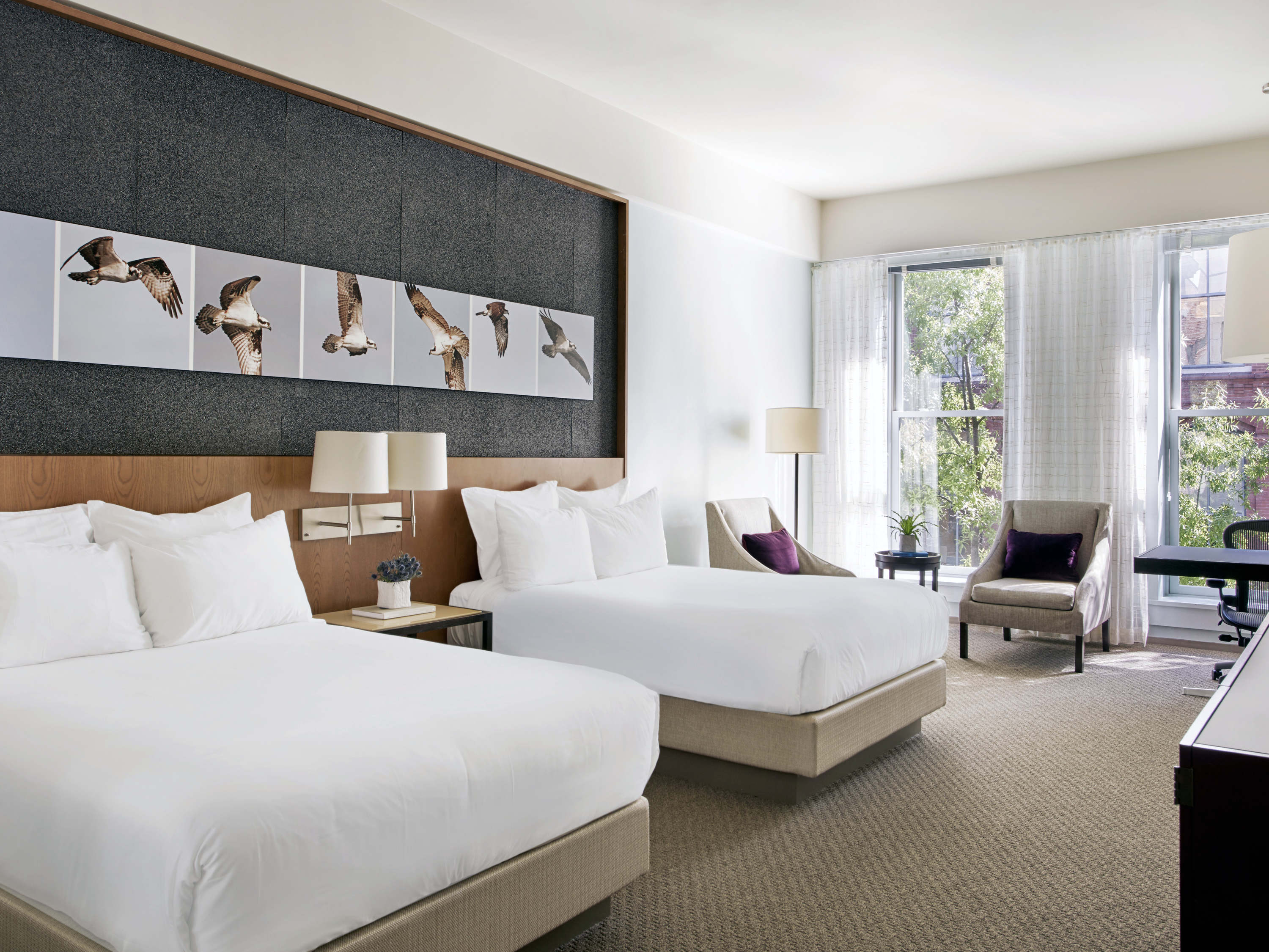 a room with two beds and a chair