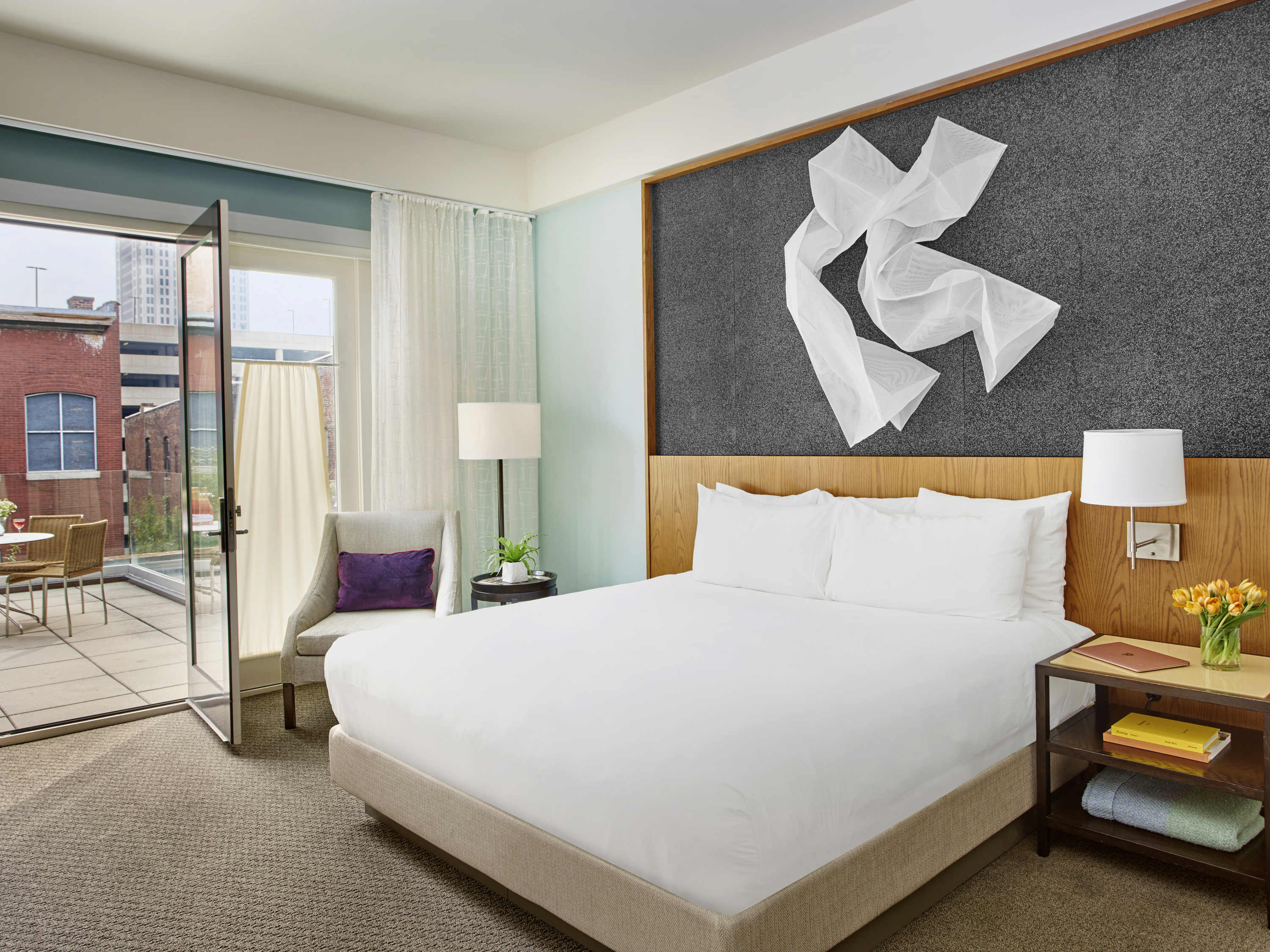 a room with a bed and a glass door