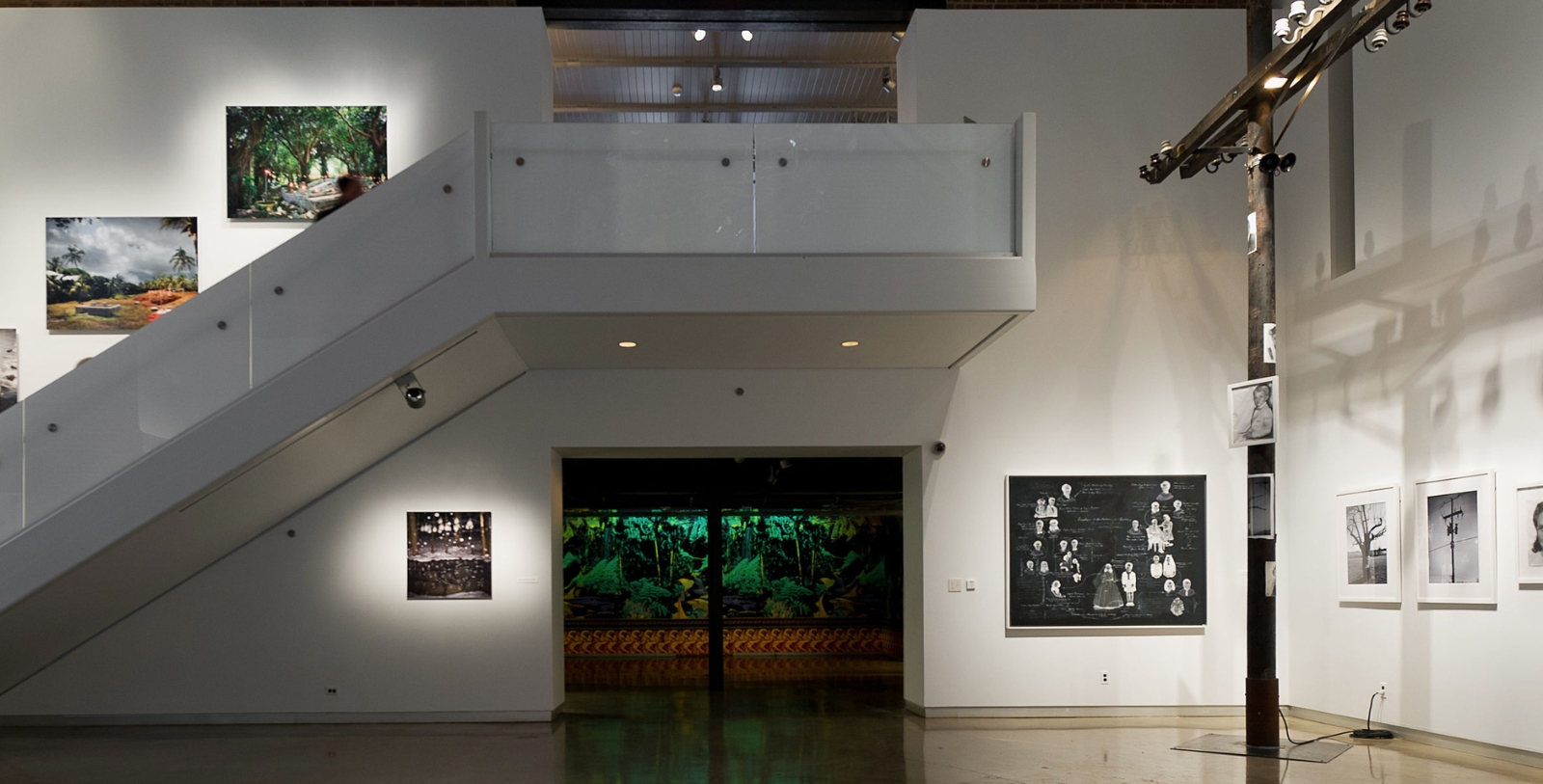 a white staircase with art on the wall
