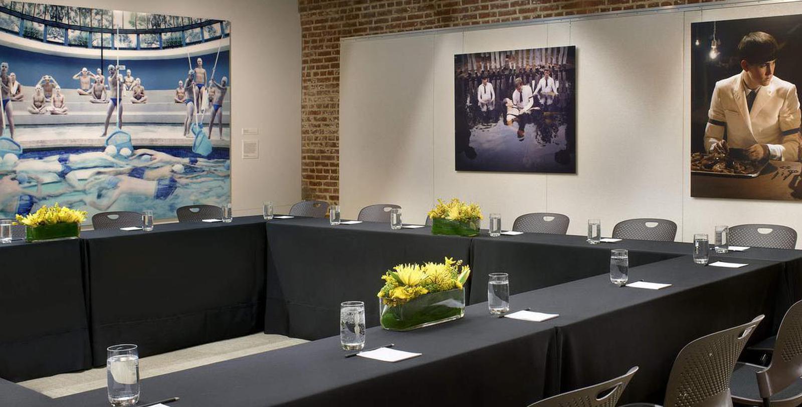 a long table with black tablecloths and glasses on it