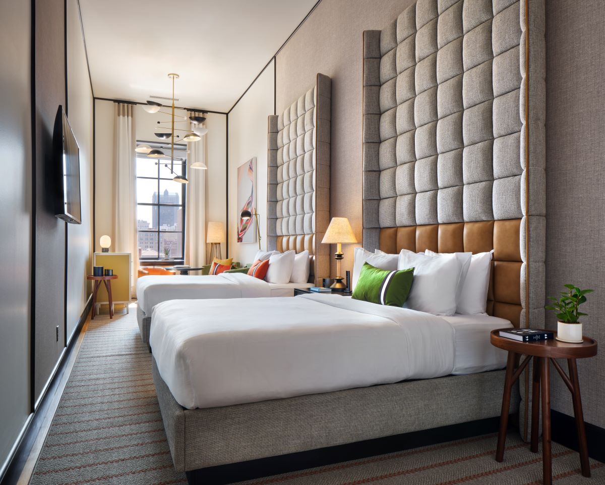a room with two beds and a television