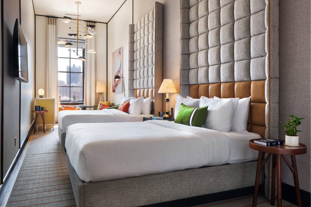 a room with two beds and a window