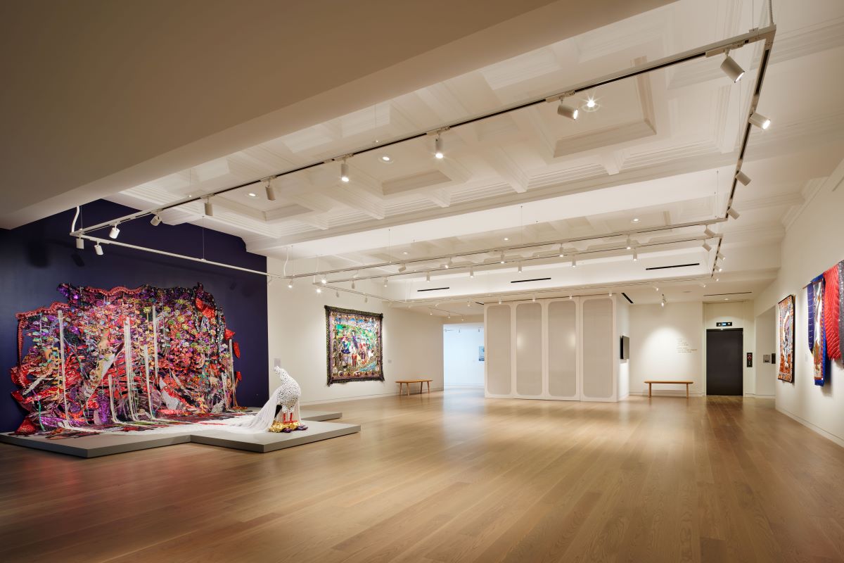 a room with a large display of art