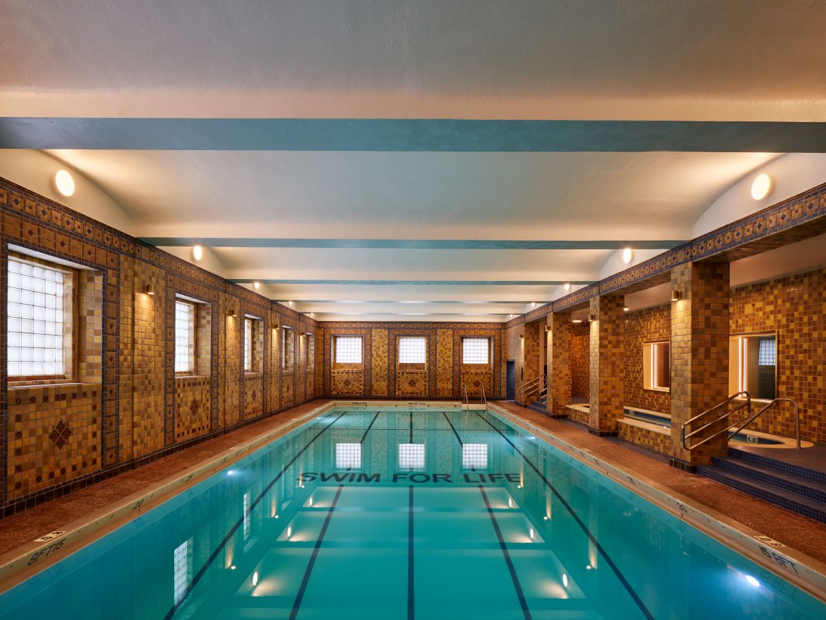 a indoor swimming pool with a tiled wall