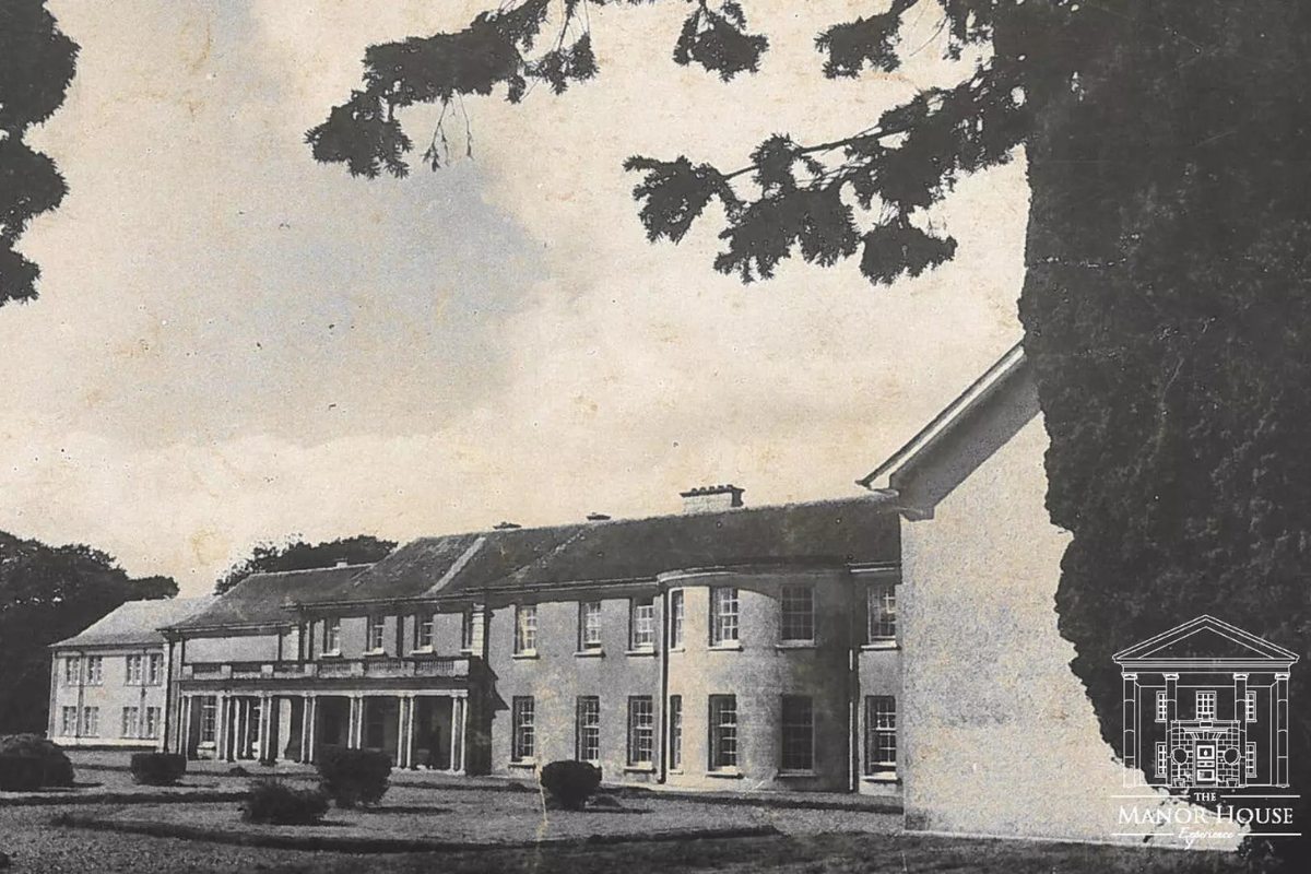 a large building with a large lawn and a tree