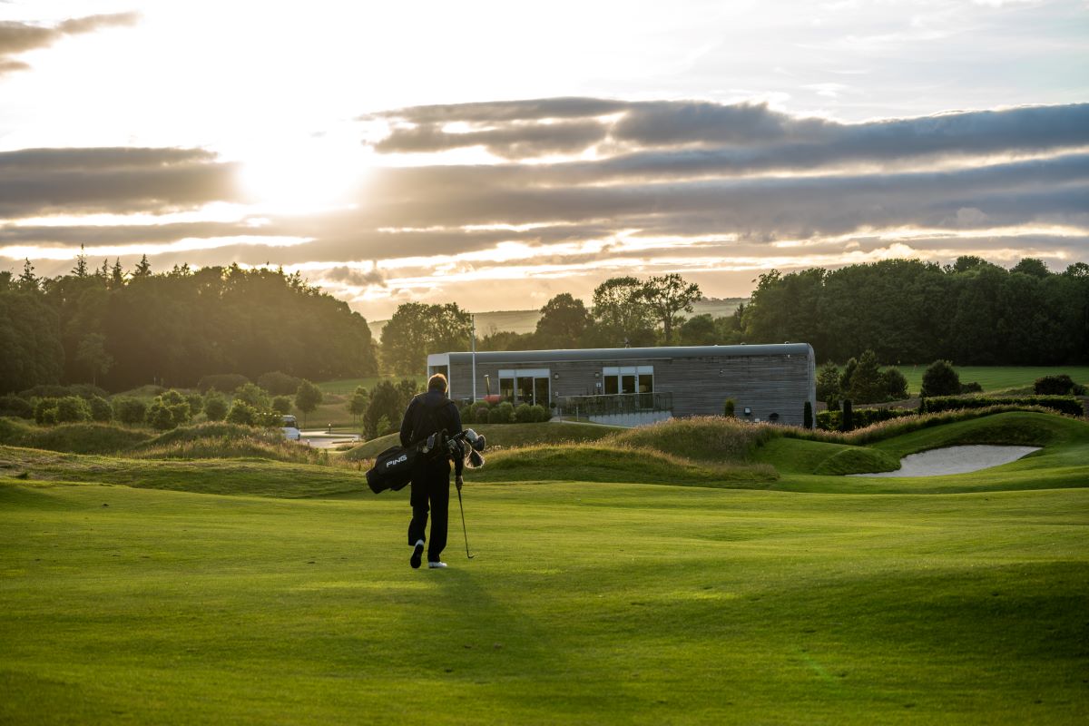 a person walking on a golf course