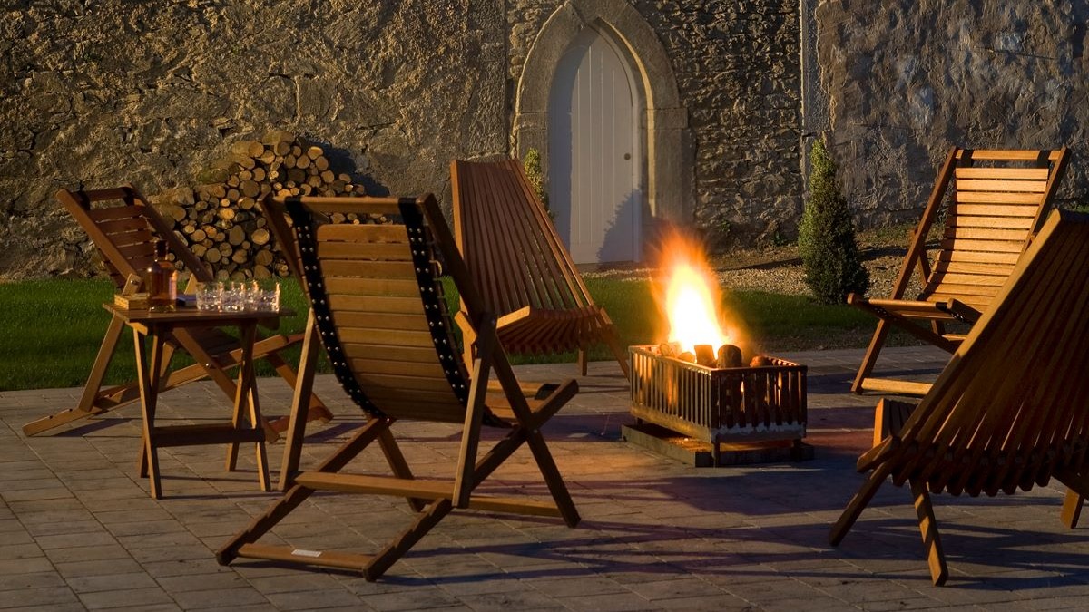 a fire pit with chairs and a table