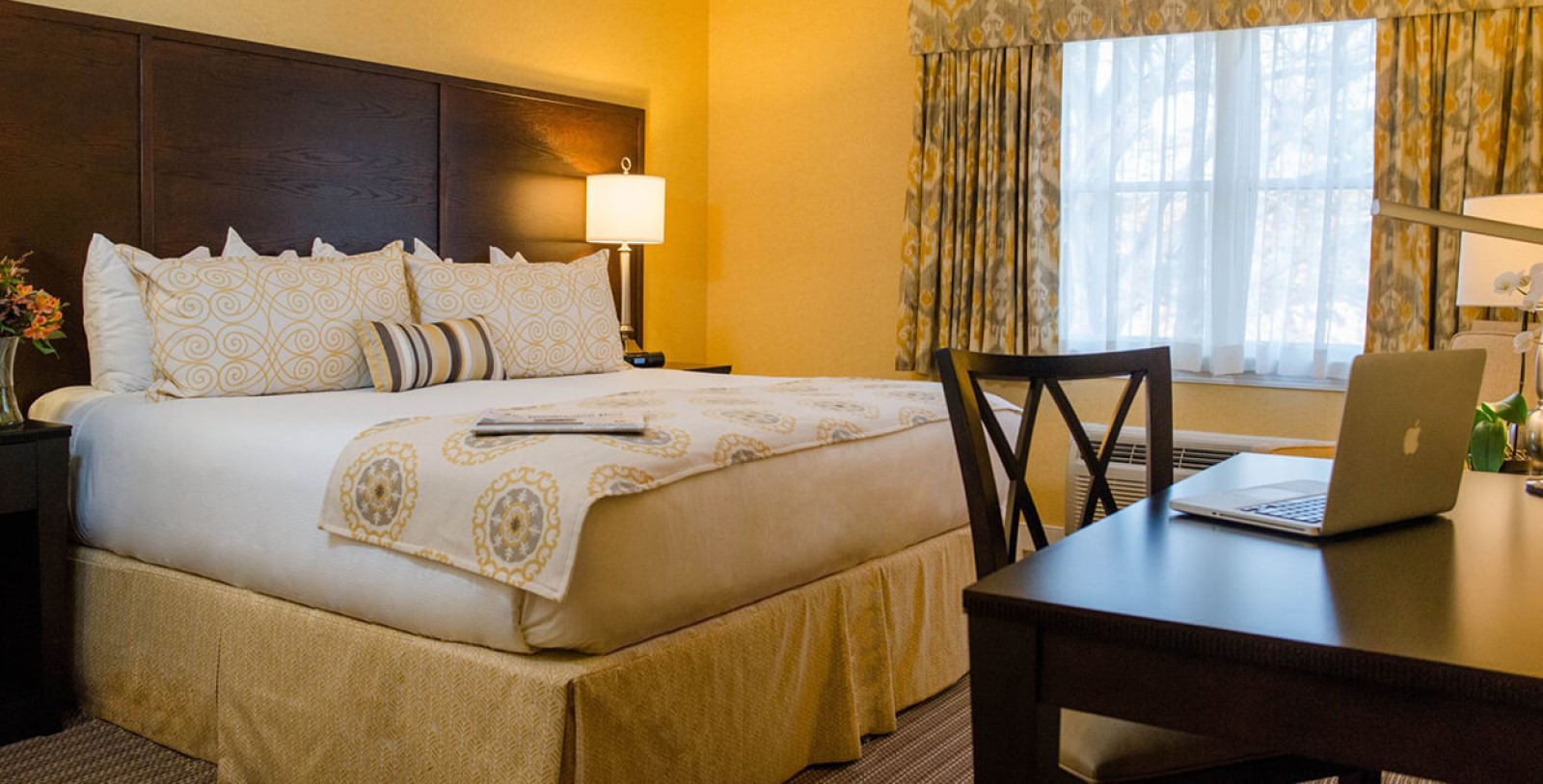 a bed with a lamp and a table in a room