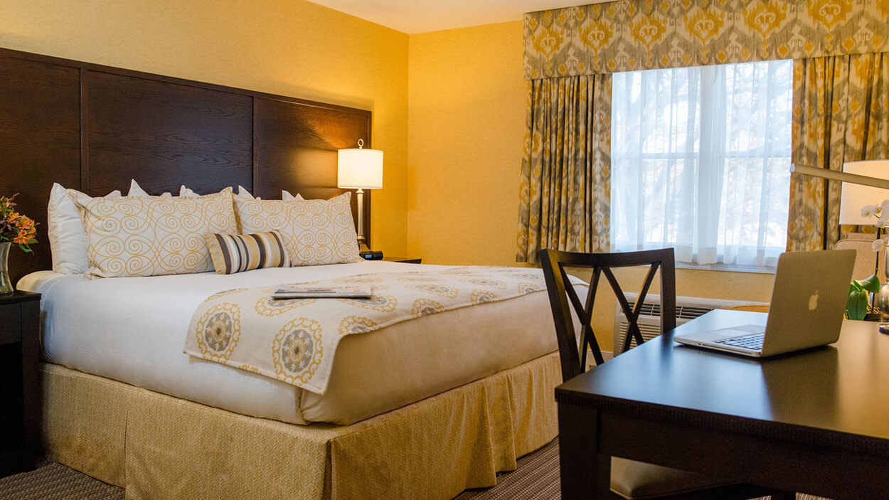 a bed with a desk and chair in a room