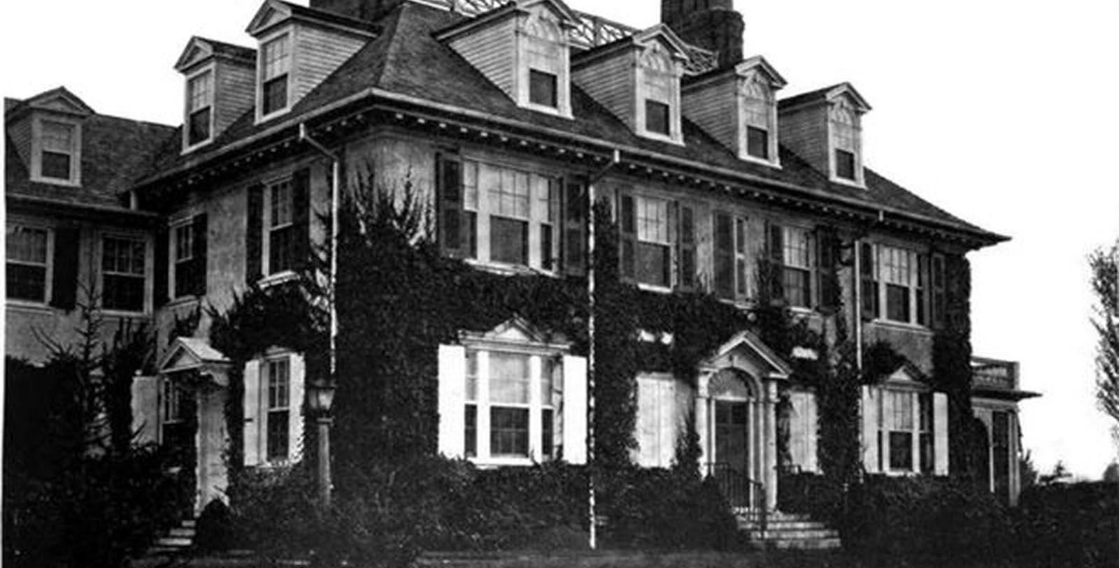 a large house with a clock on the front