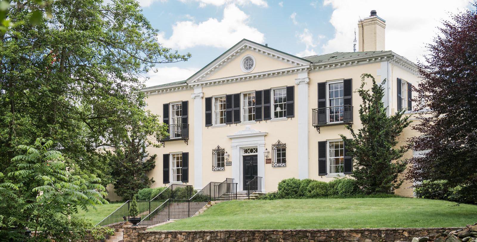 a large white house with black shutters