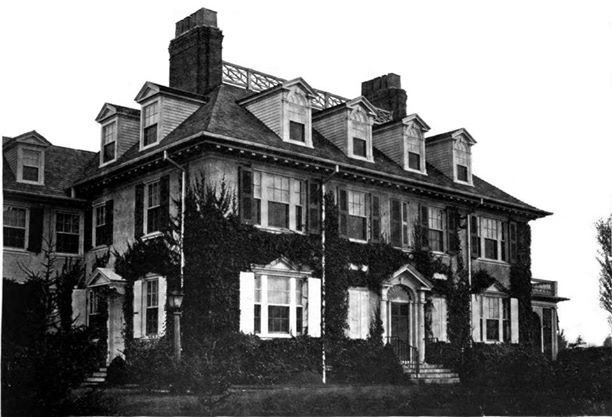 a large house with ivy on the front