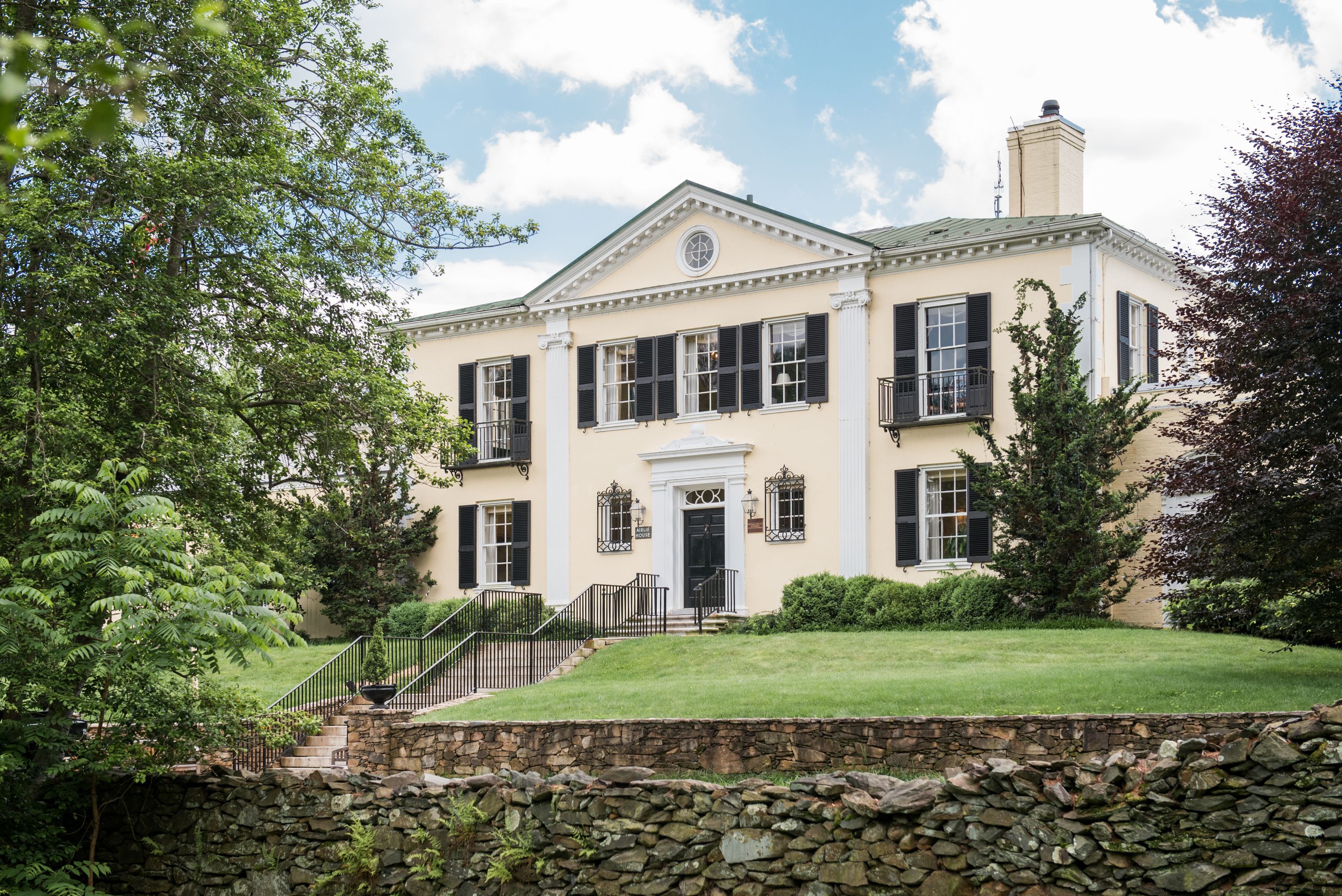 a large white house with black shutters