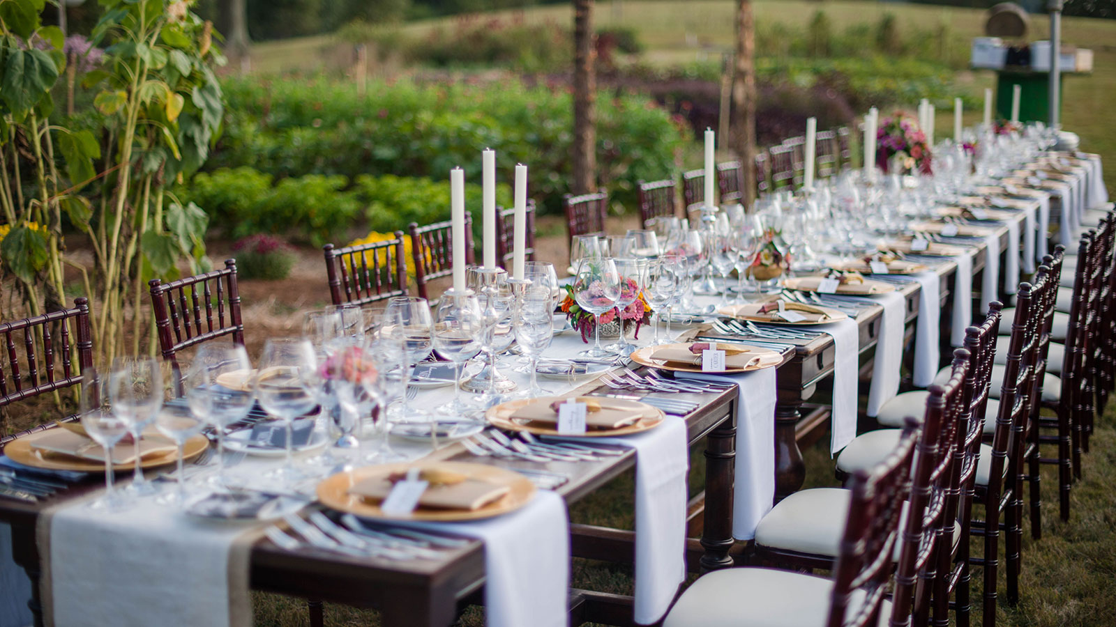 a long table with wine glasses and candles