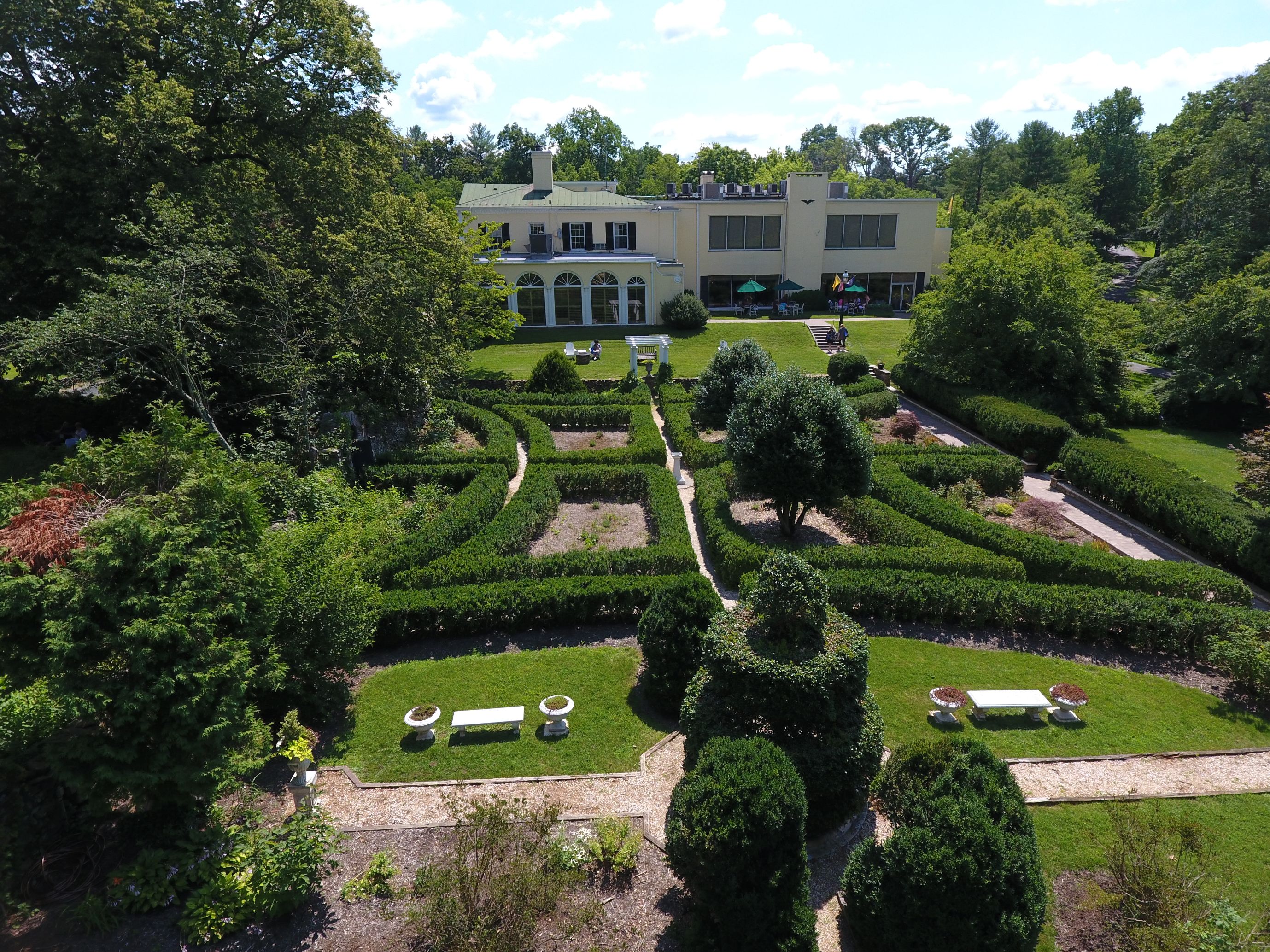 a large garden with bushes and trees