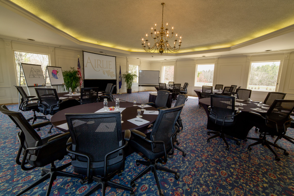 a room with a large table and chairs