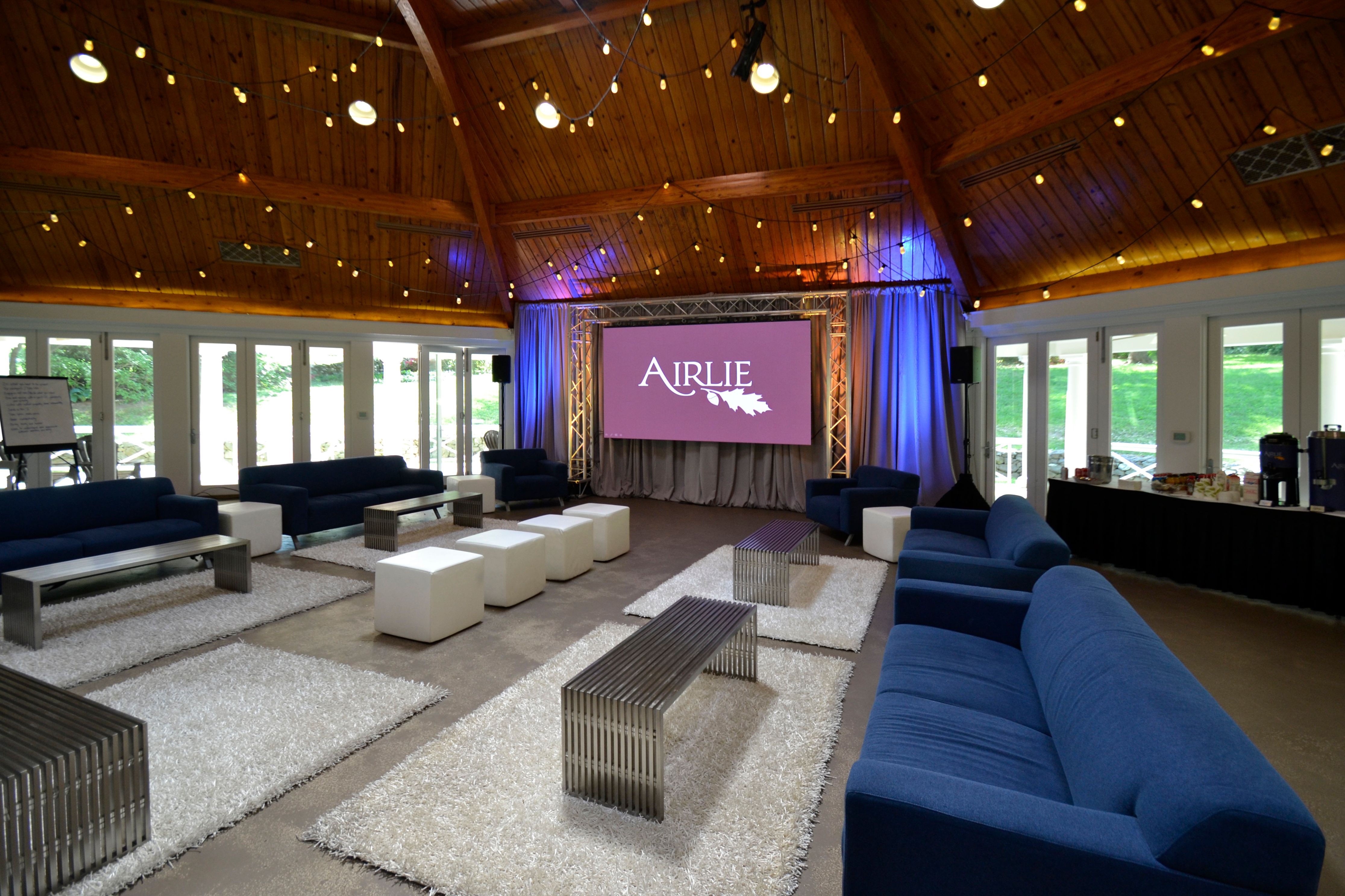 a room with a large screen and a couch