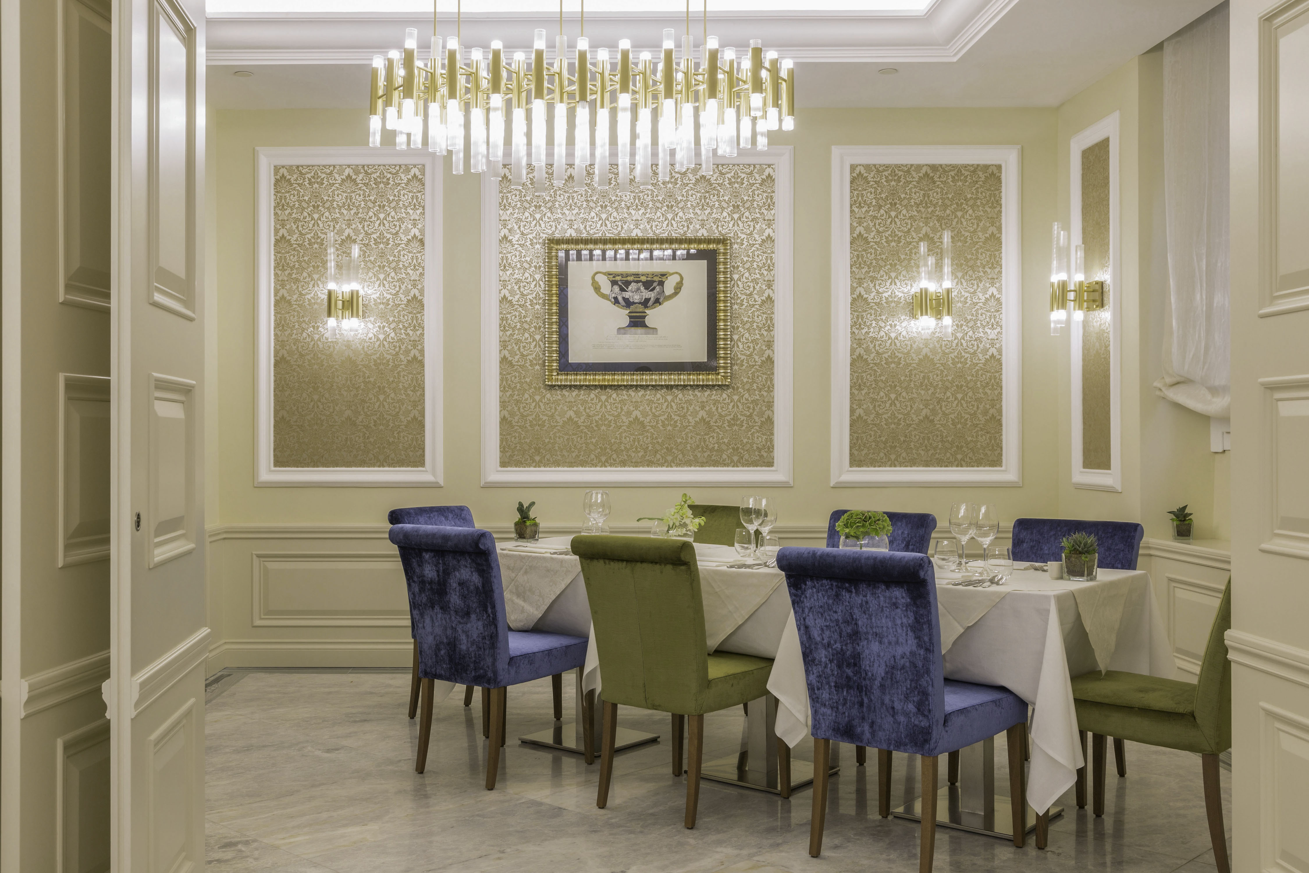 a room with a chandelier and tables