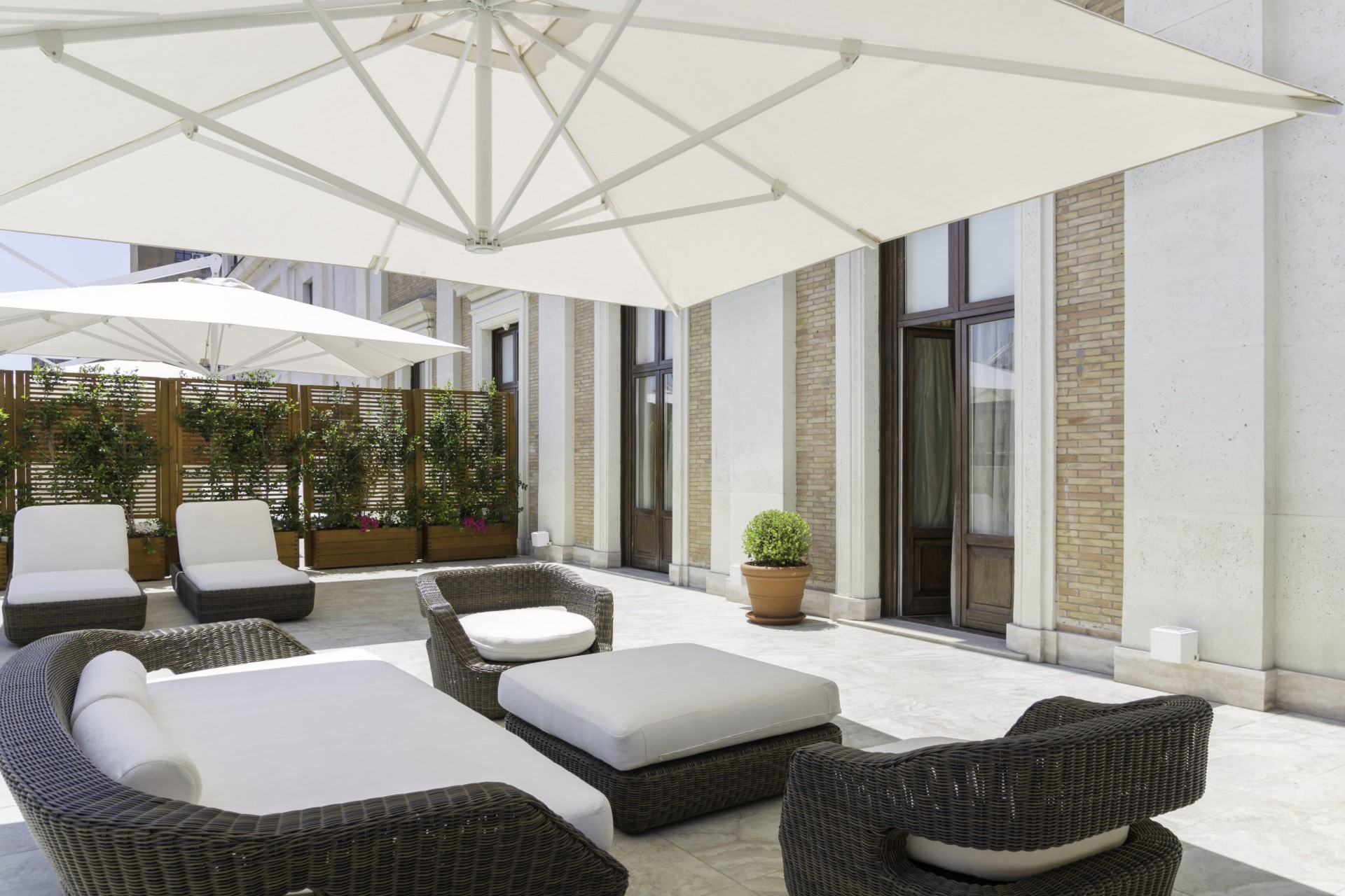a patio with chairs and umbrellas
