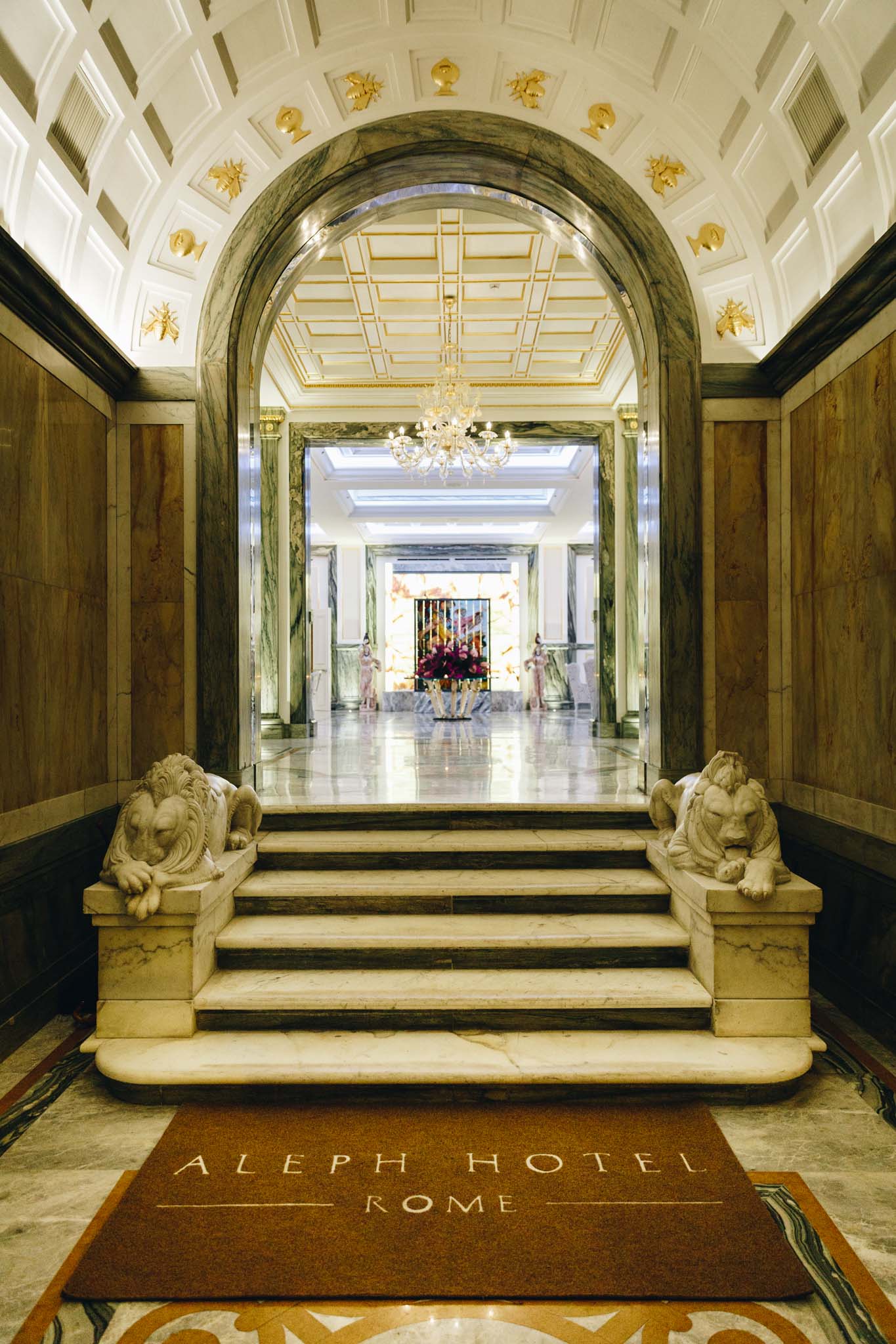 a marble staircase with lions statues in a building