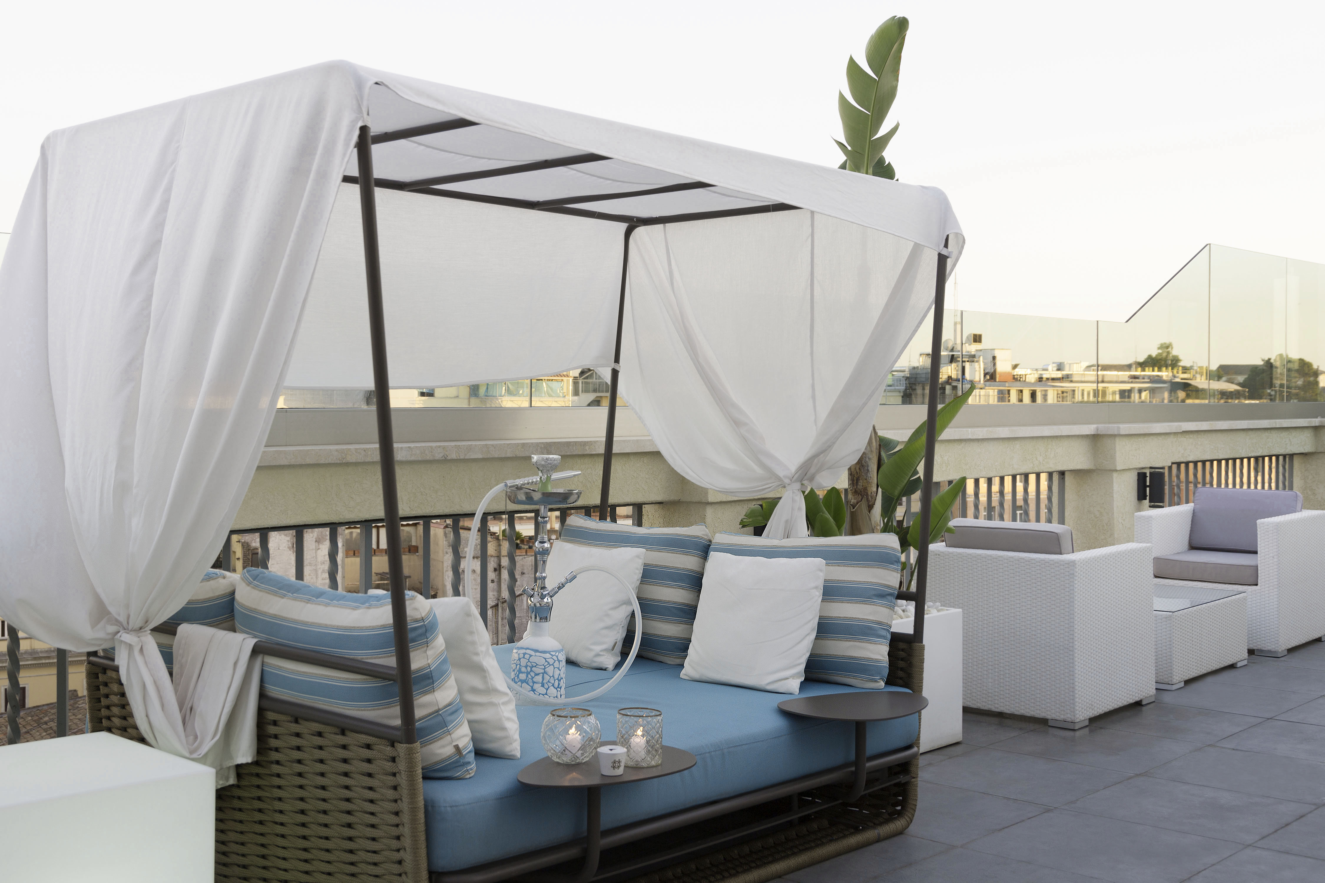 a patio with a canopy bed and a table