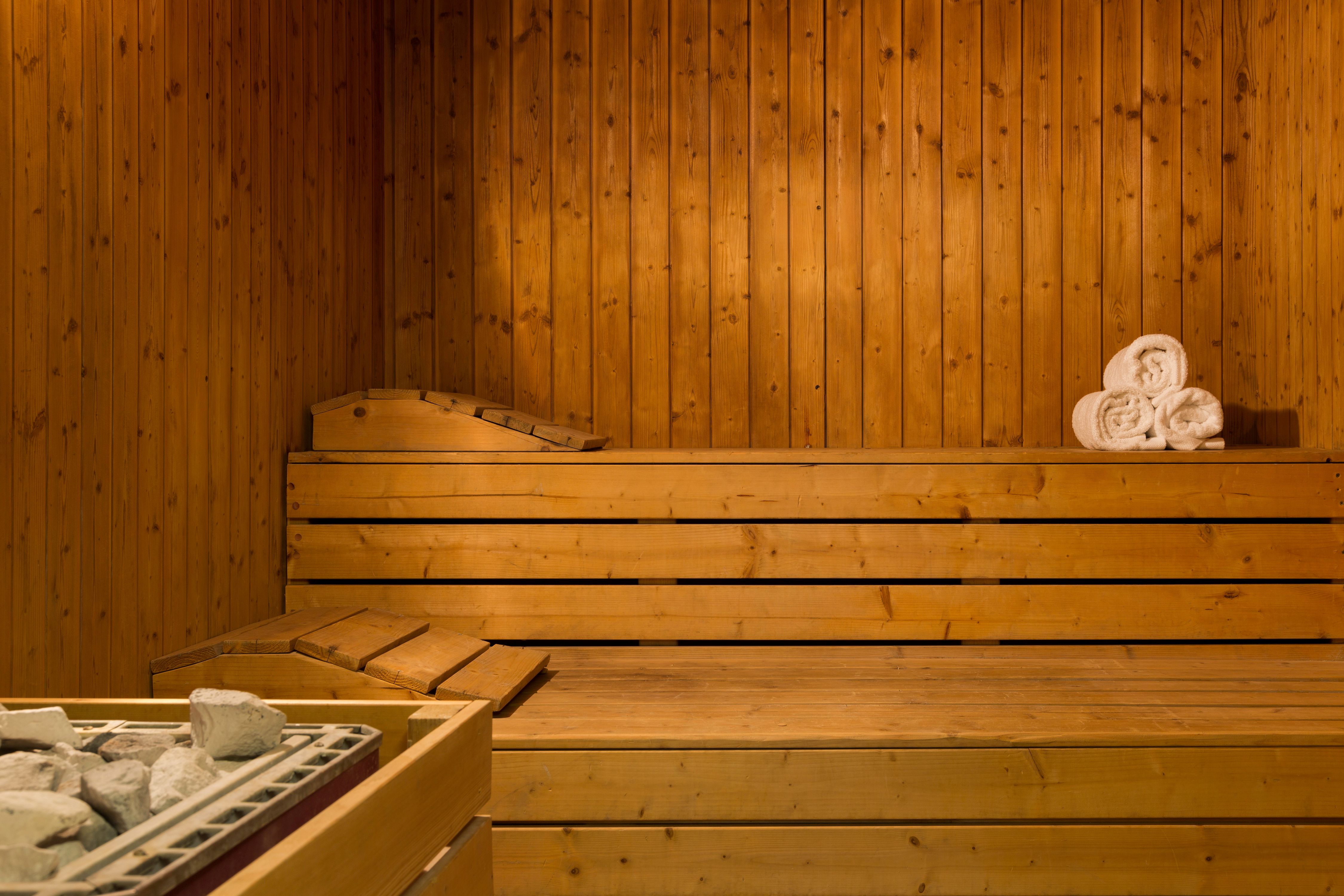 a wooden sauna with a towel on top